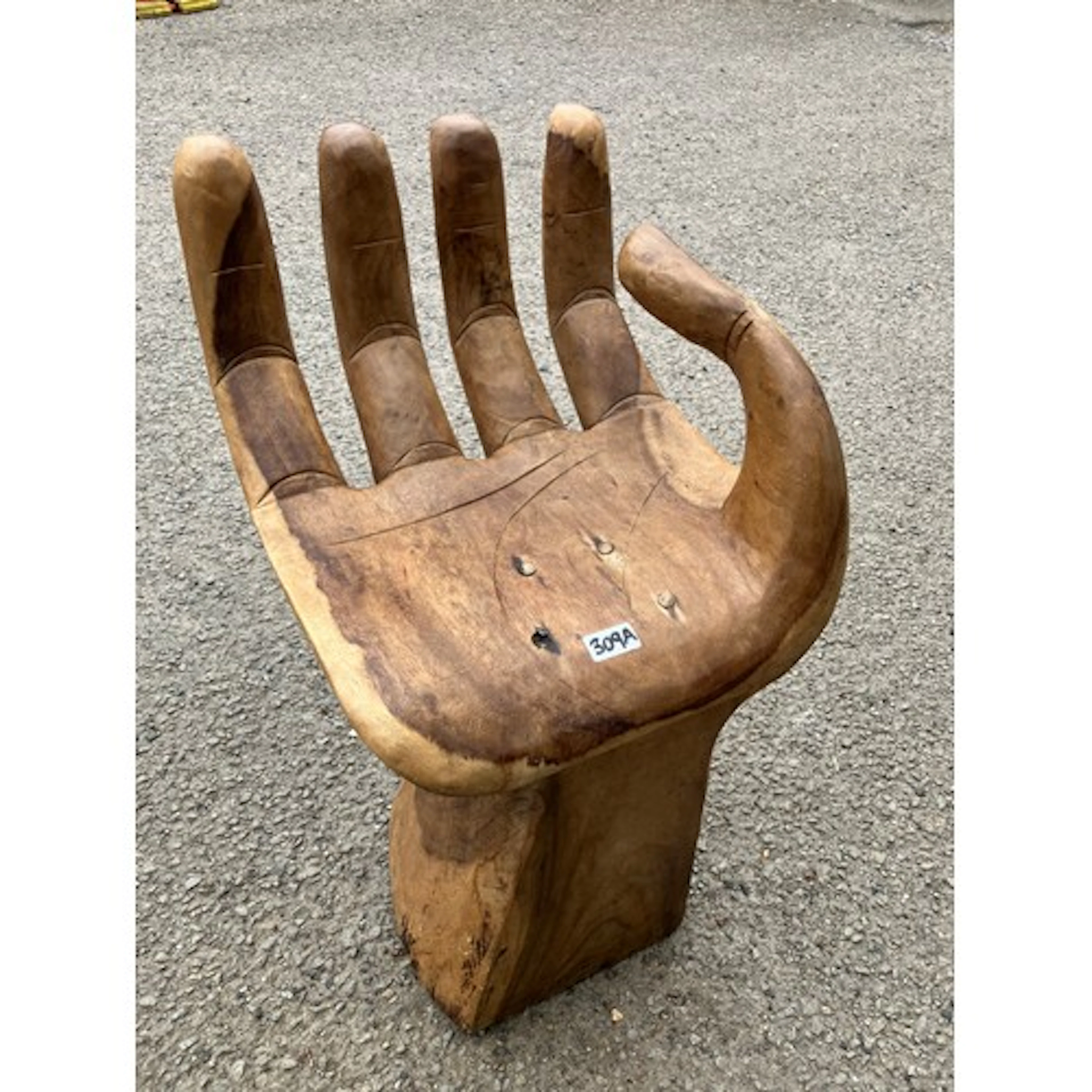 Carved hardwood sculptural chair modelled as an open right h...