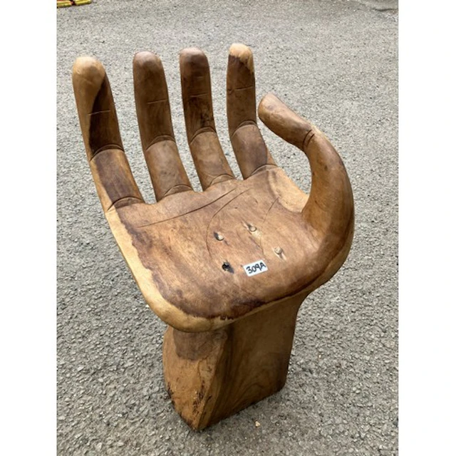 Carved hardwood sculptural chair modelled as an open right h...