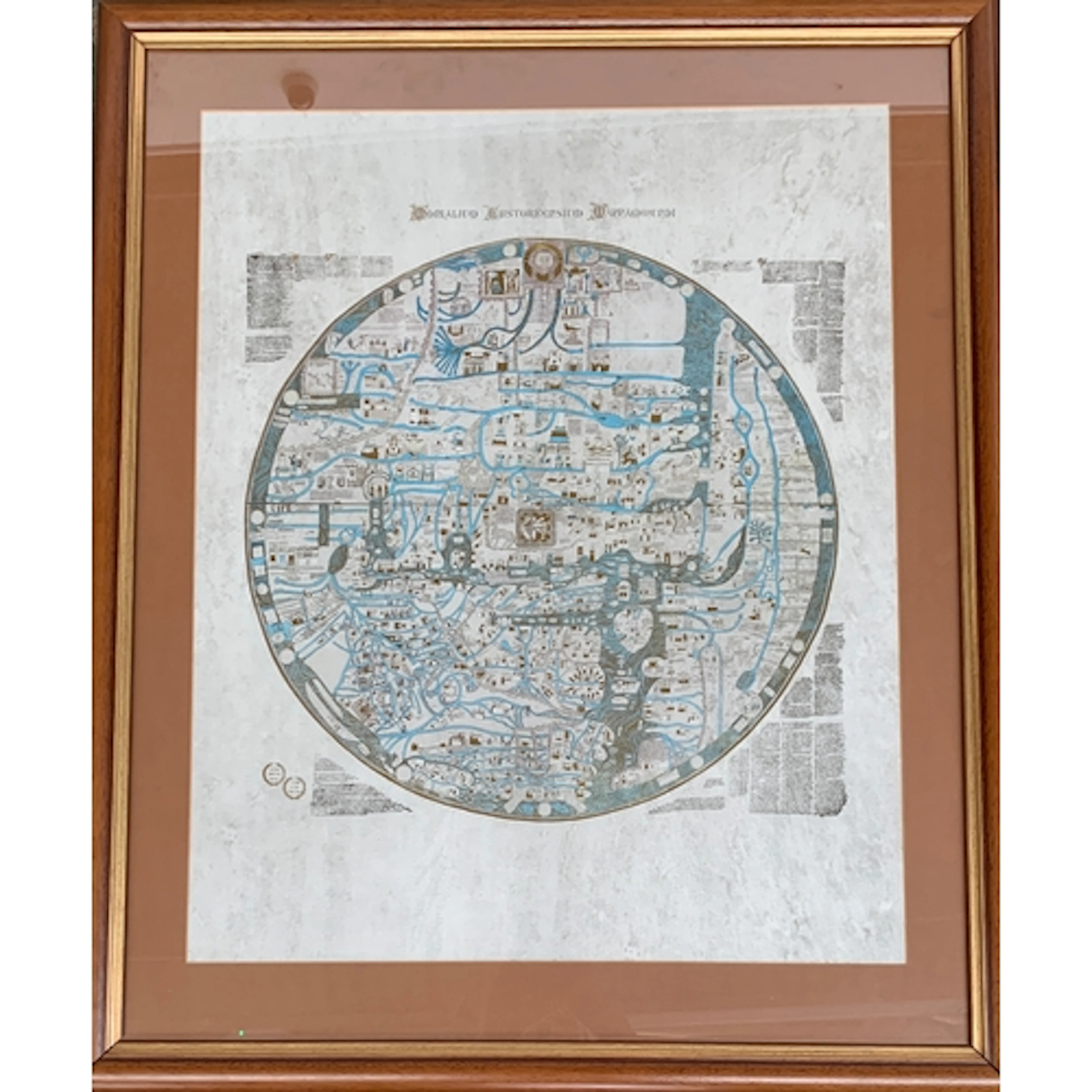 A framed reproduction of the Ebstorf mappa mundi, heightened...