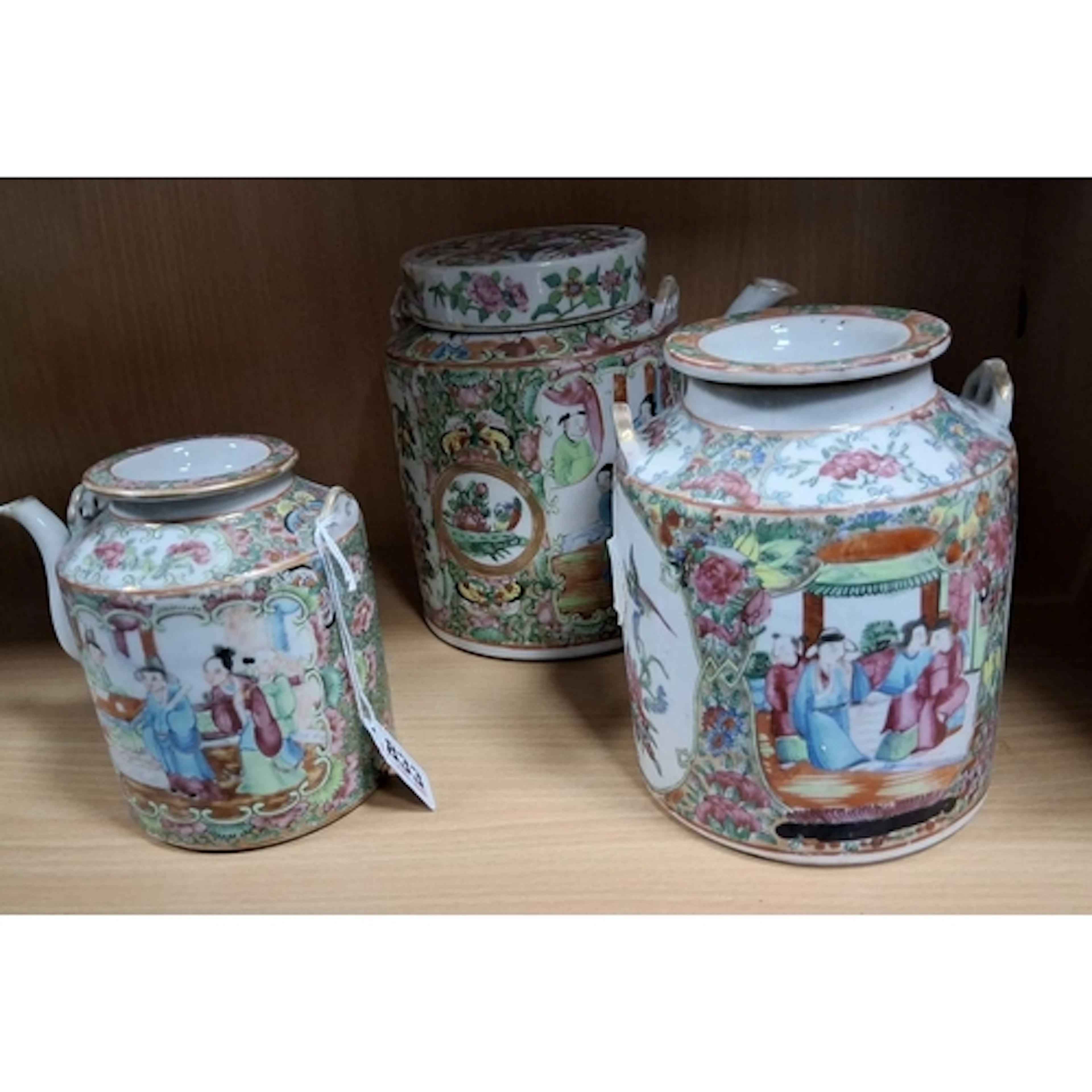 THREE ORIENTAL FAMILLE ROSE TEAPOTS, featuring brightly colo...