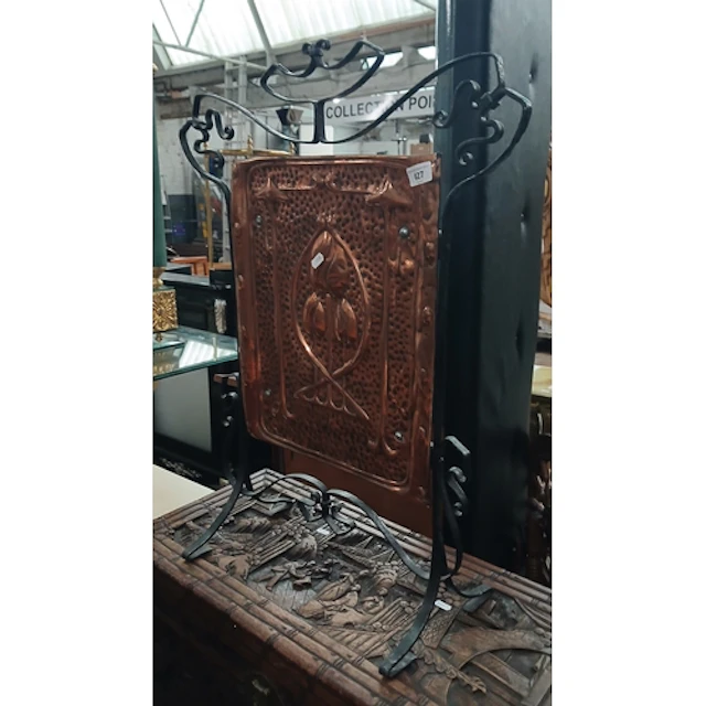 An Arts & Crafts style fire screen.