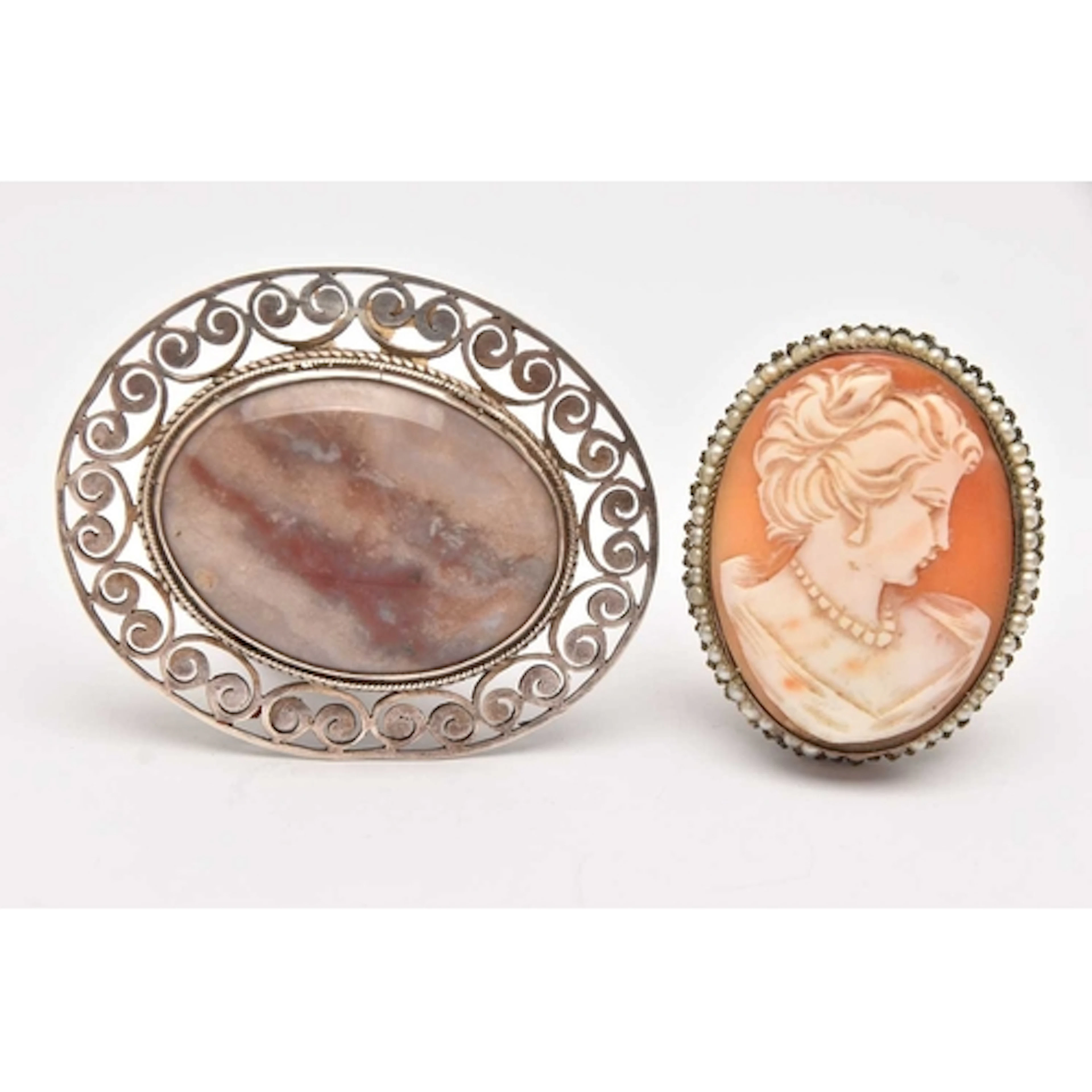 TWO BROOCHES, an oval cabochon agate stone, collet set in wh...