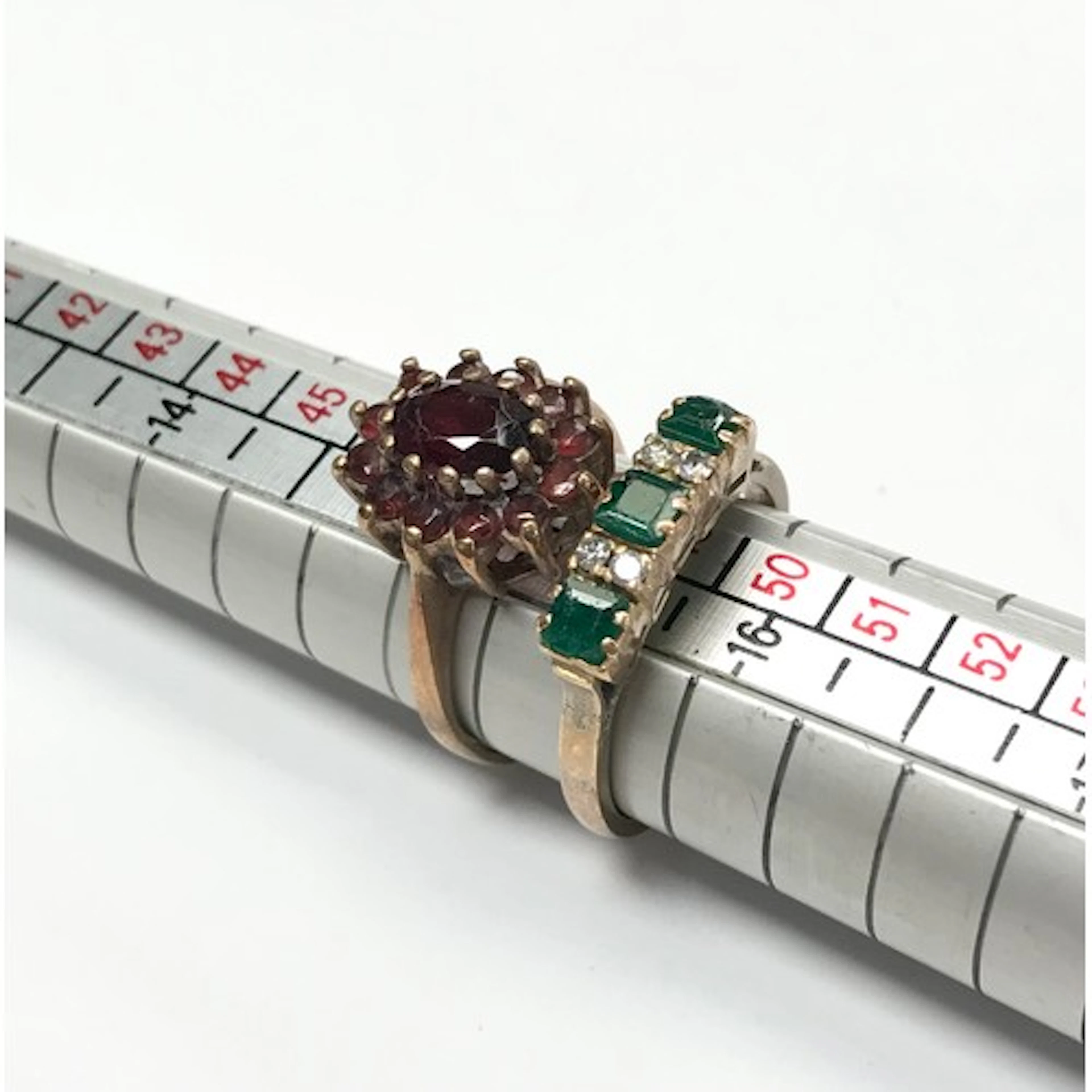 A garnet cluster ring, yellow metal indistinctly marked; an ...