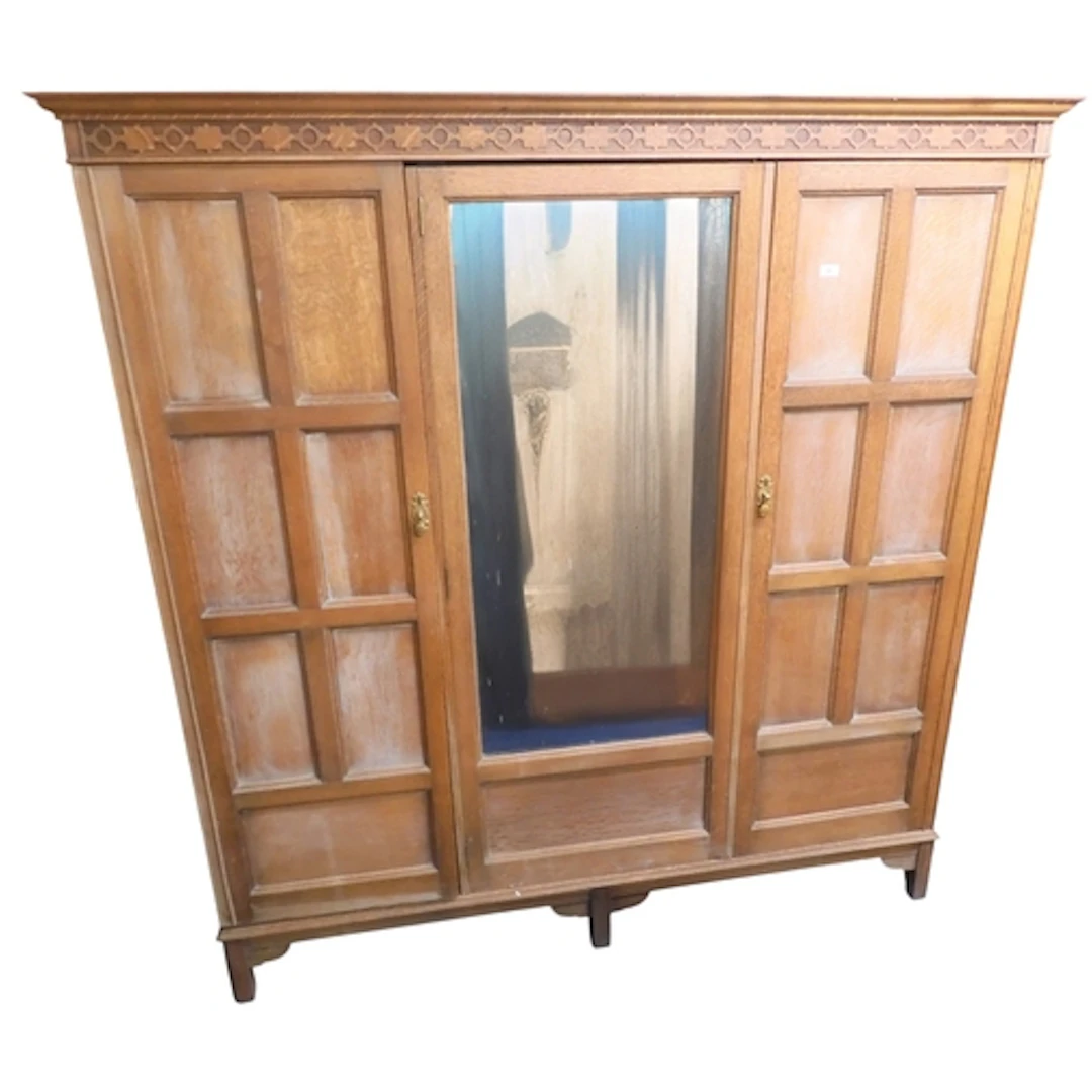 An early 20th century oak three door wardrobe with moulded c...
