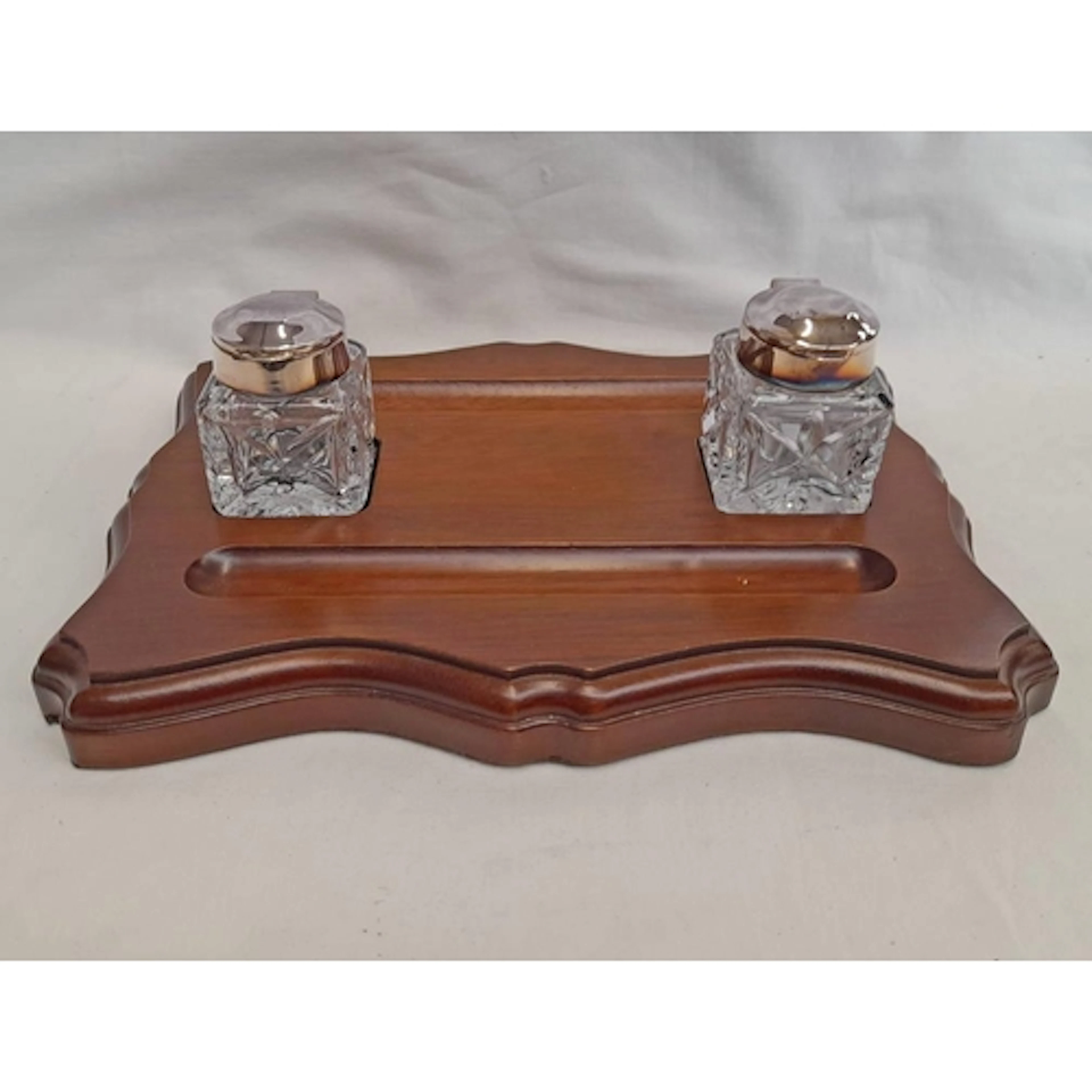 MODERN SILVER MOUNTED FACETED GLASS INKWELLS ON A FITTED WOO...