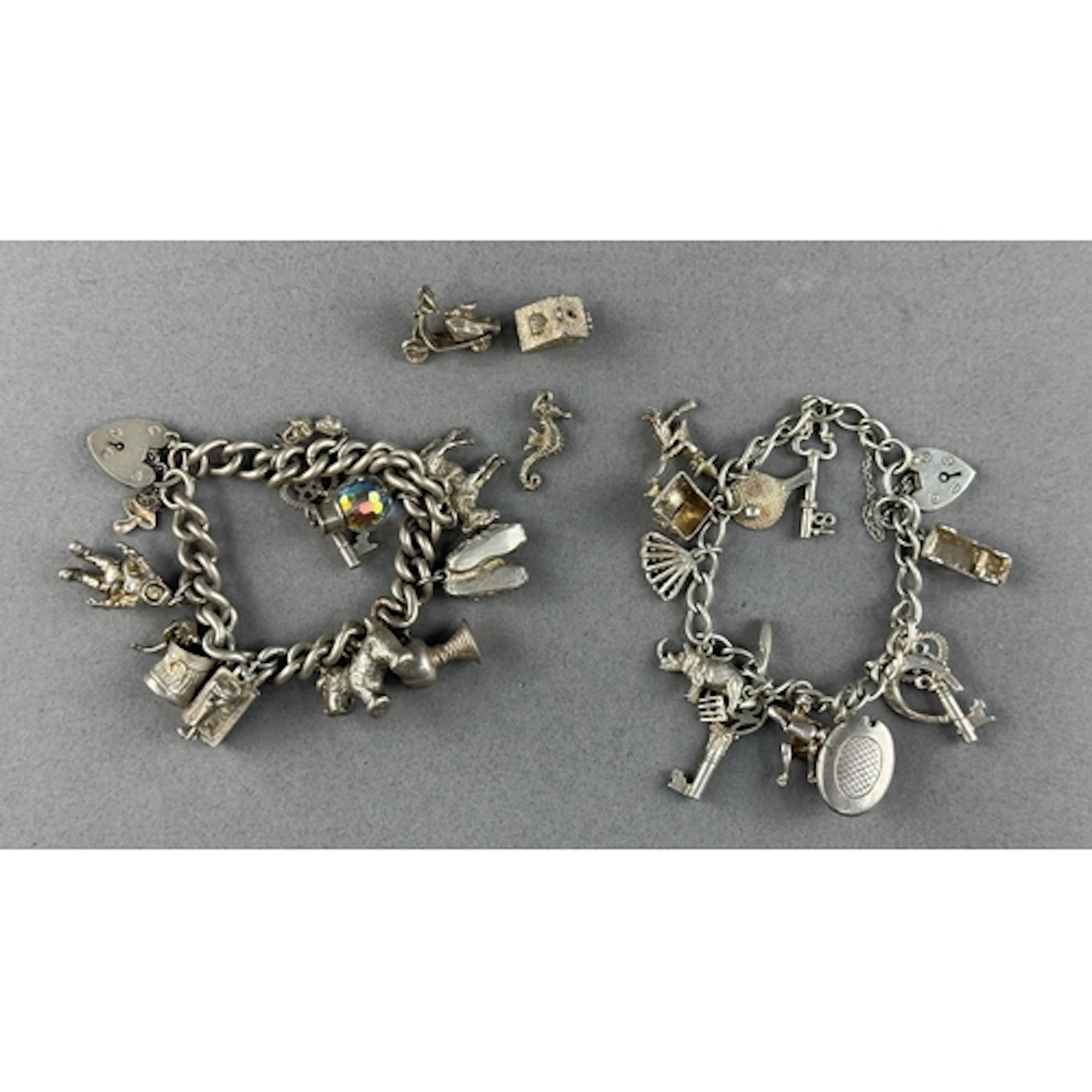 Jewellery: two charm bracelets, one with ten charms, the oth...