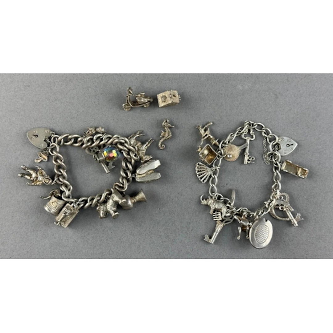 Jewellery: two charm bracelets, one with ten charms, the oth...