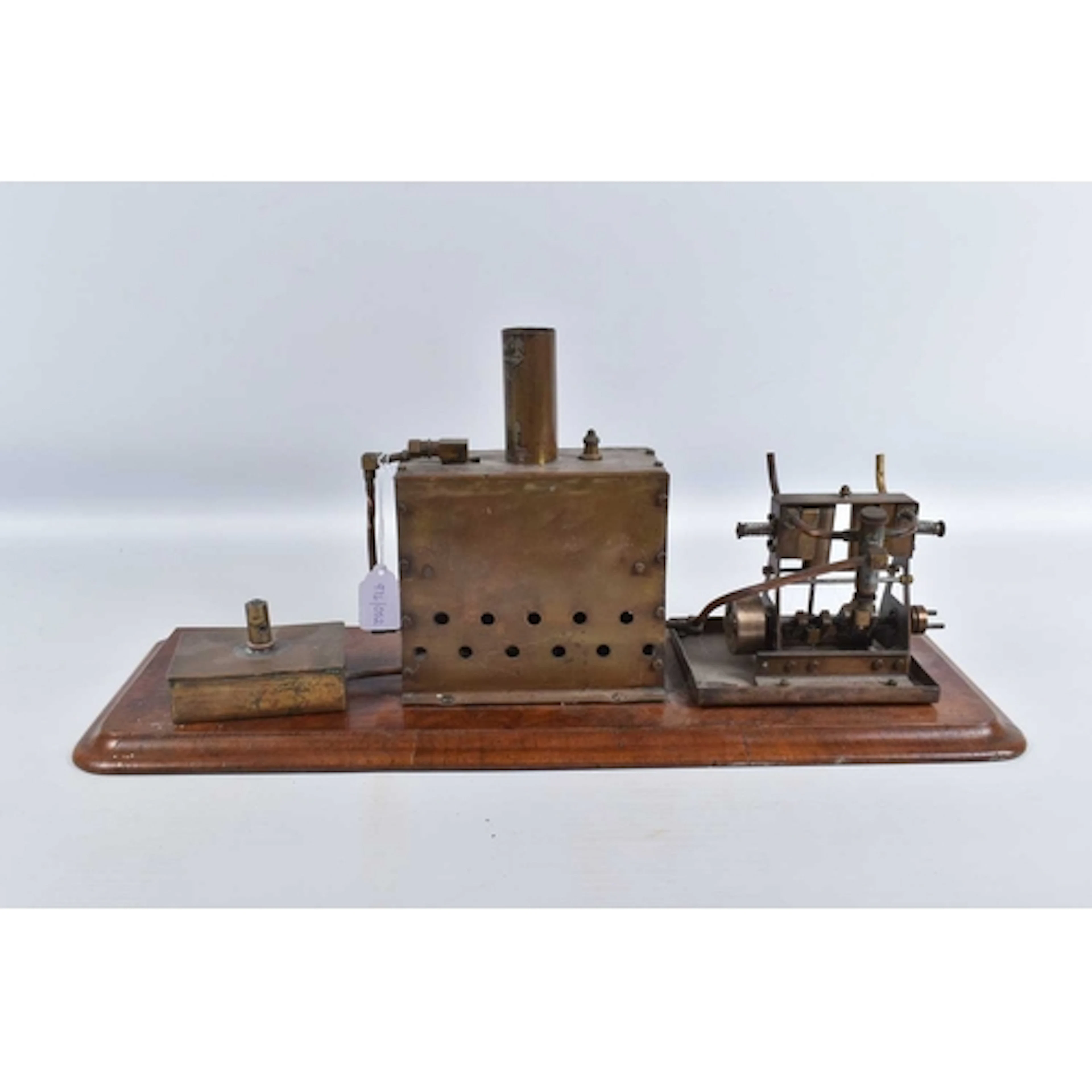 A HORIZONTAL LIVE STEAM BOILER POWERING A VERTICAL TWIN CYLI...
