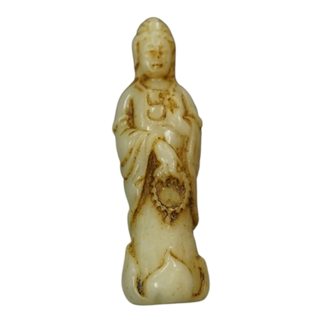 A miniature Chinese white and russet jade figure of Gnanyin,...