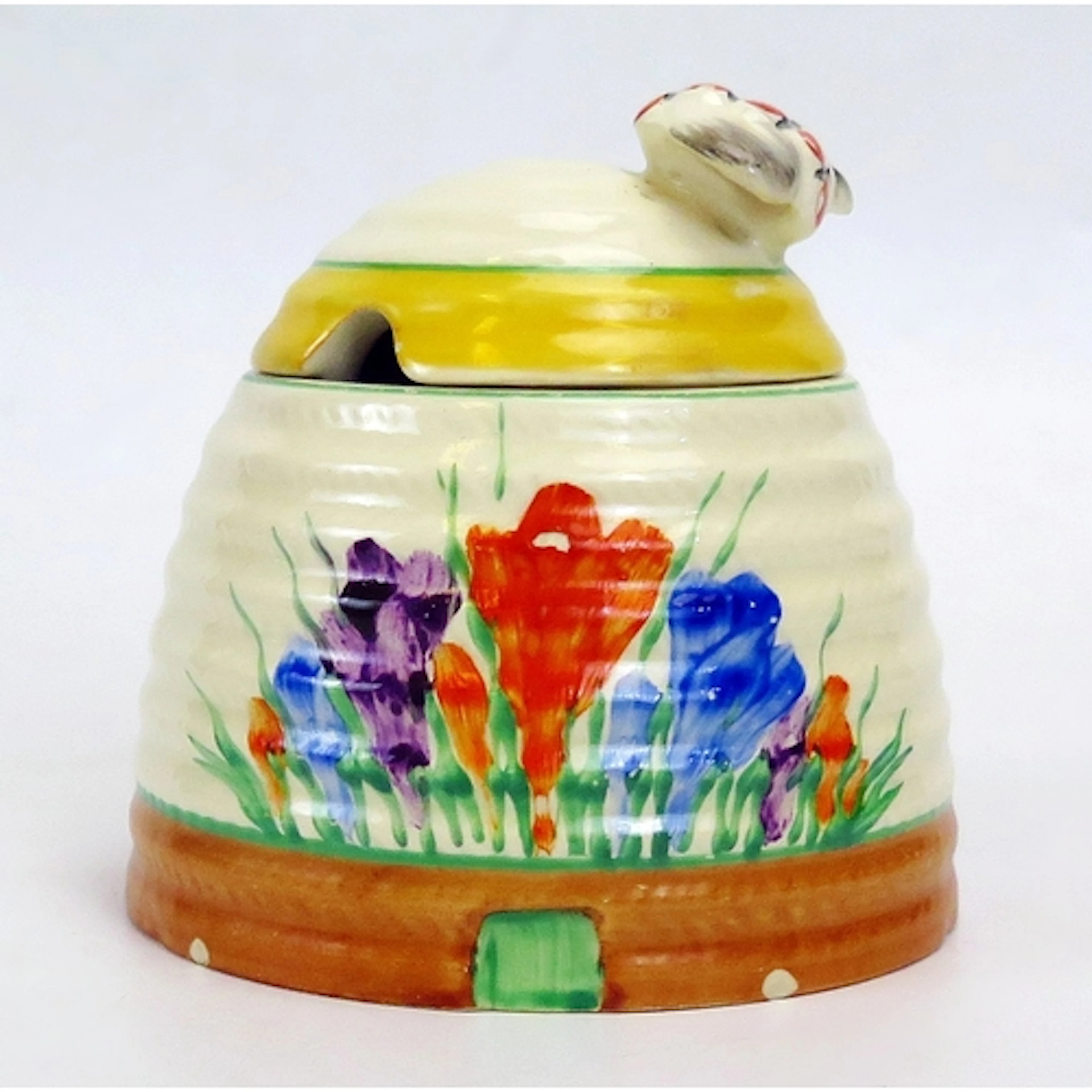 Clarice Cliff, a bee hive honey pot with painted crocus patt...
