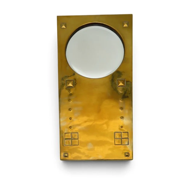 AN ARTS AND CRAFTS BRASS FRAMED MIRROR of rectangular form w...