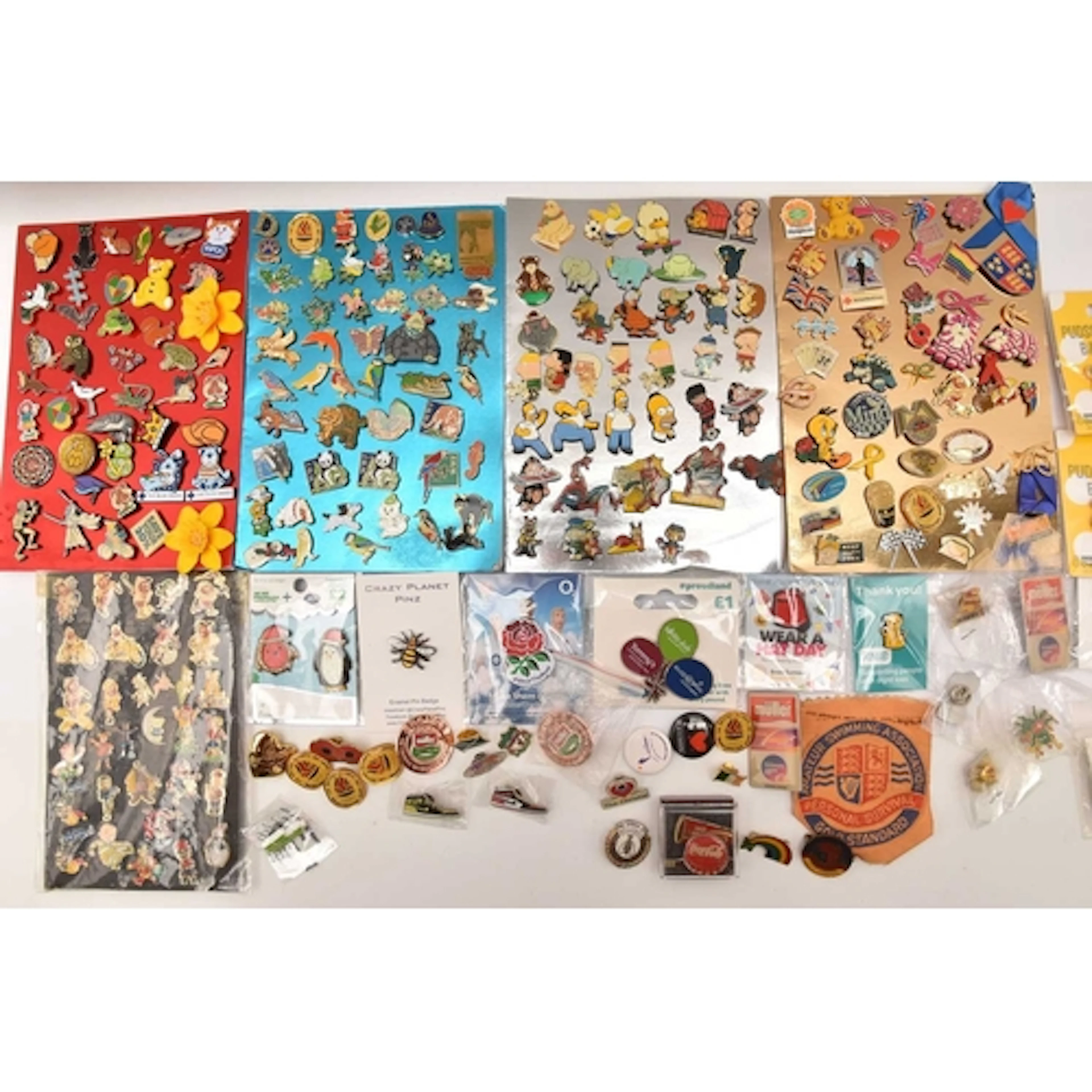 A LARGE ASSORTMENT OF BADGES, to include characters from The...