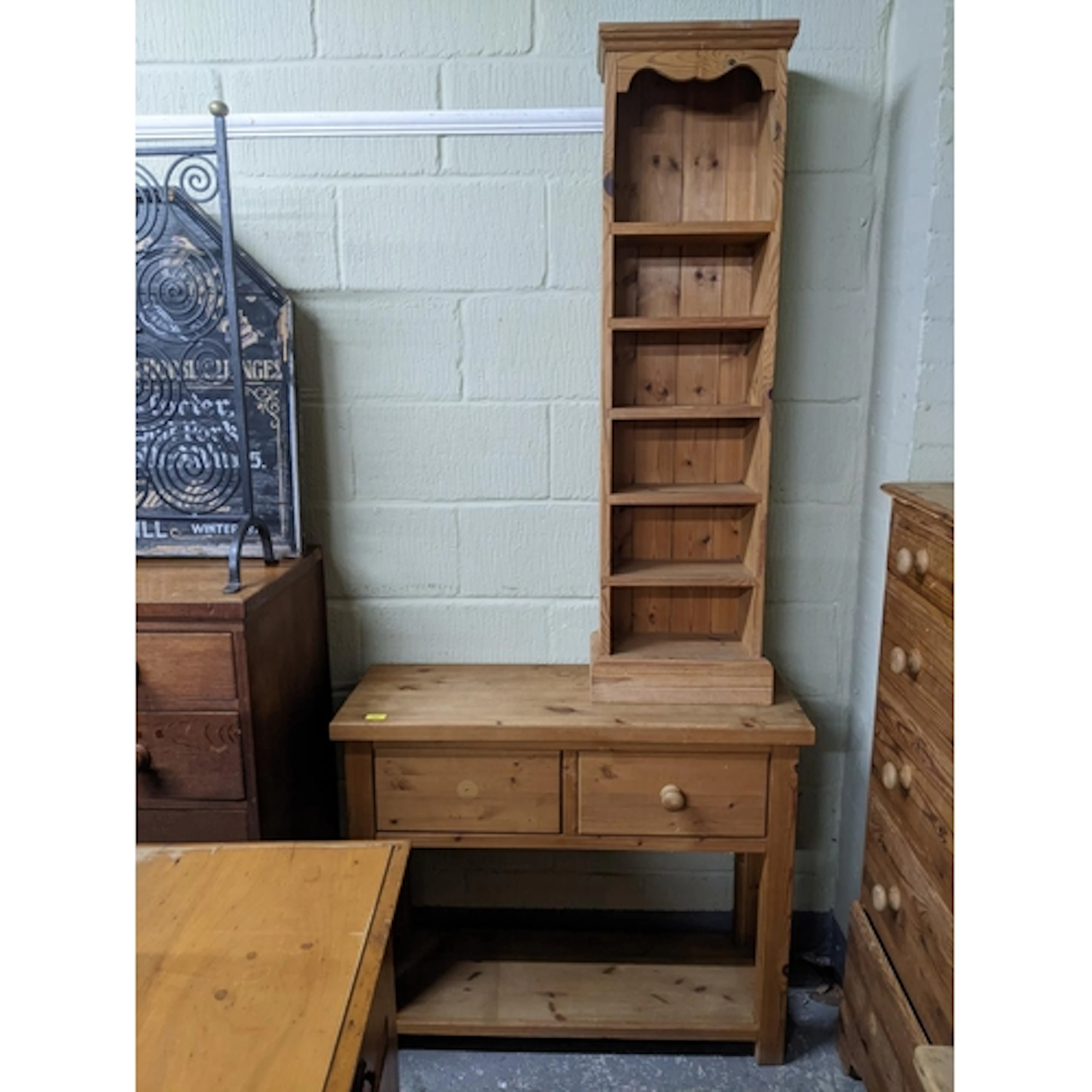 A modern pine bookcase, 128cms high x 37cms wide x 21cms dee...