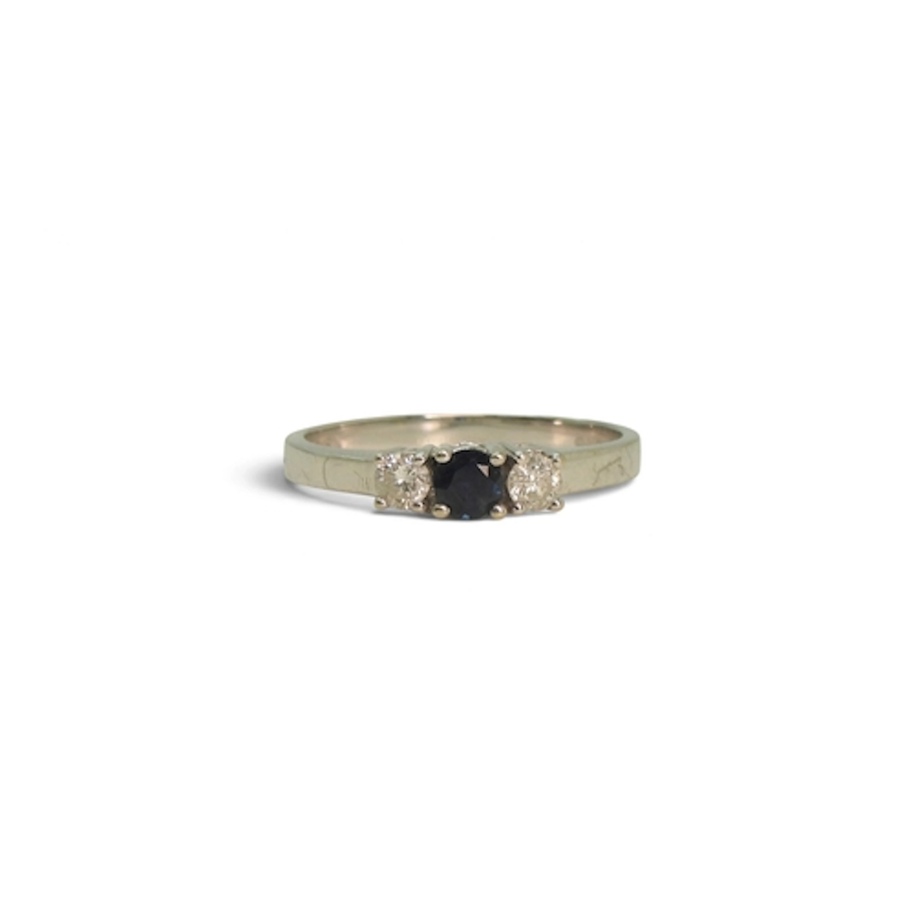 An 18ct white gold sapphire and diamond three stone ring, se...