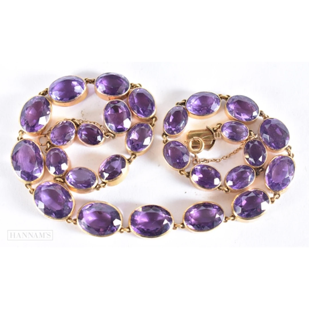 AN ANTIQUE YELLOW METAL AND AMETHYST RIVIERE NECKLACE. 46.7 ...