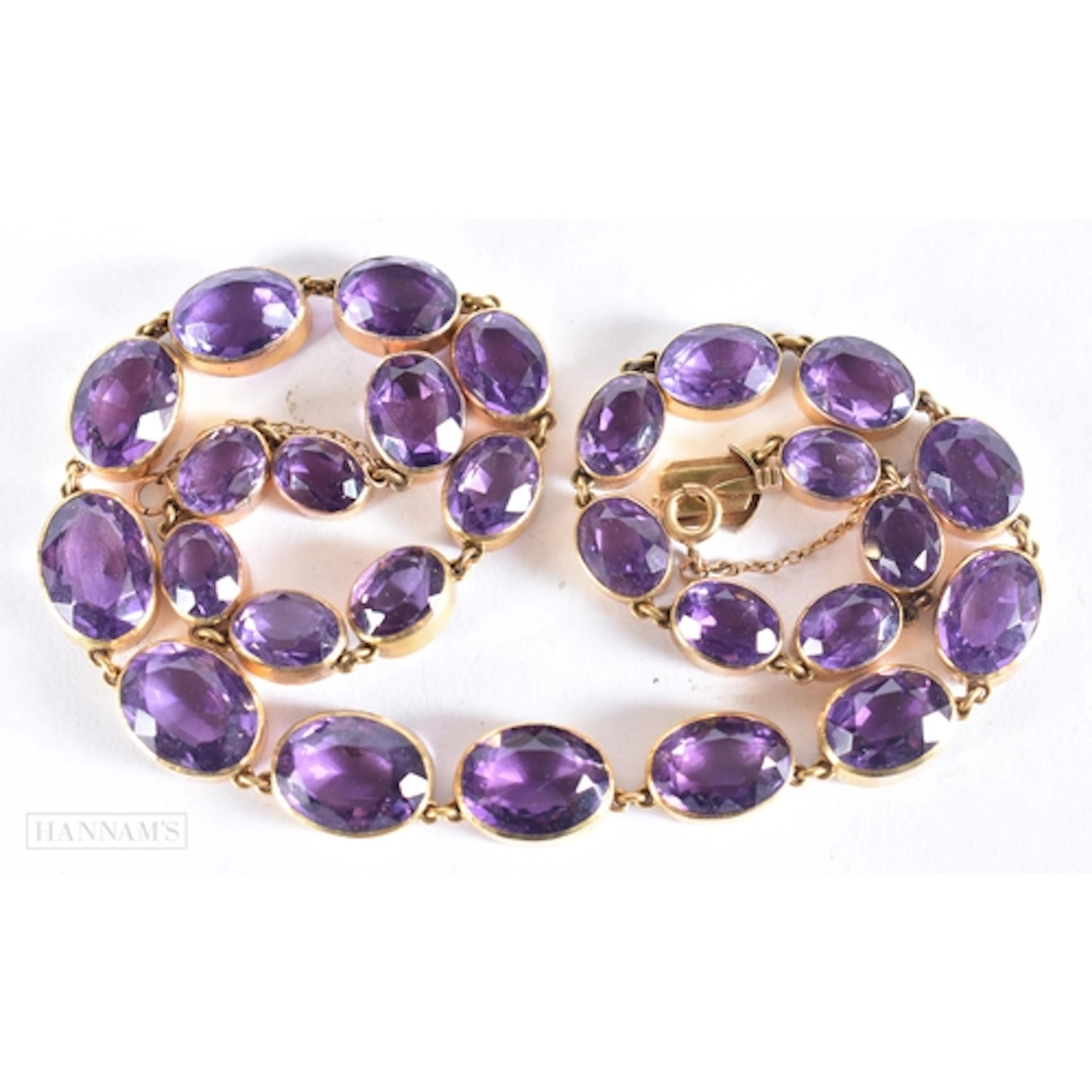 AN ANTIQUE YELLOW METAL AND AMETHYST RIVIERE NECKLACE. 46.7 ...