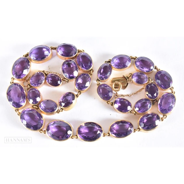 AN ANTIQUE YELLOW METAL AND AMETHYST RIVIERE NECKLACE. 46.7 ...