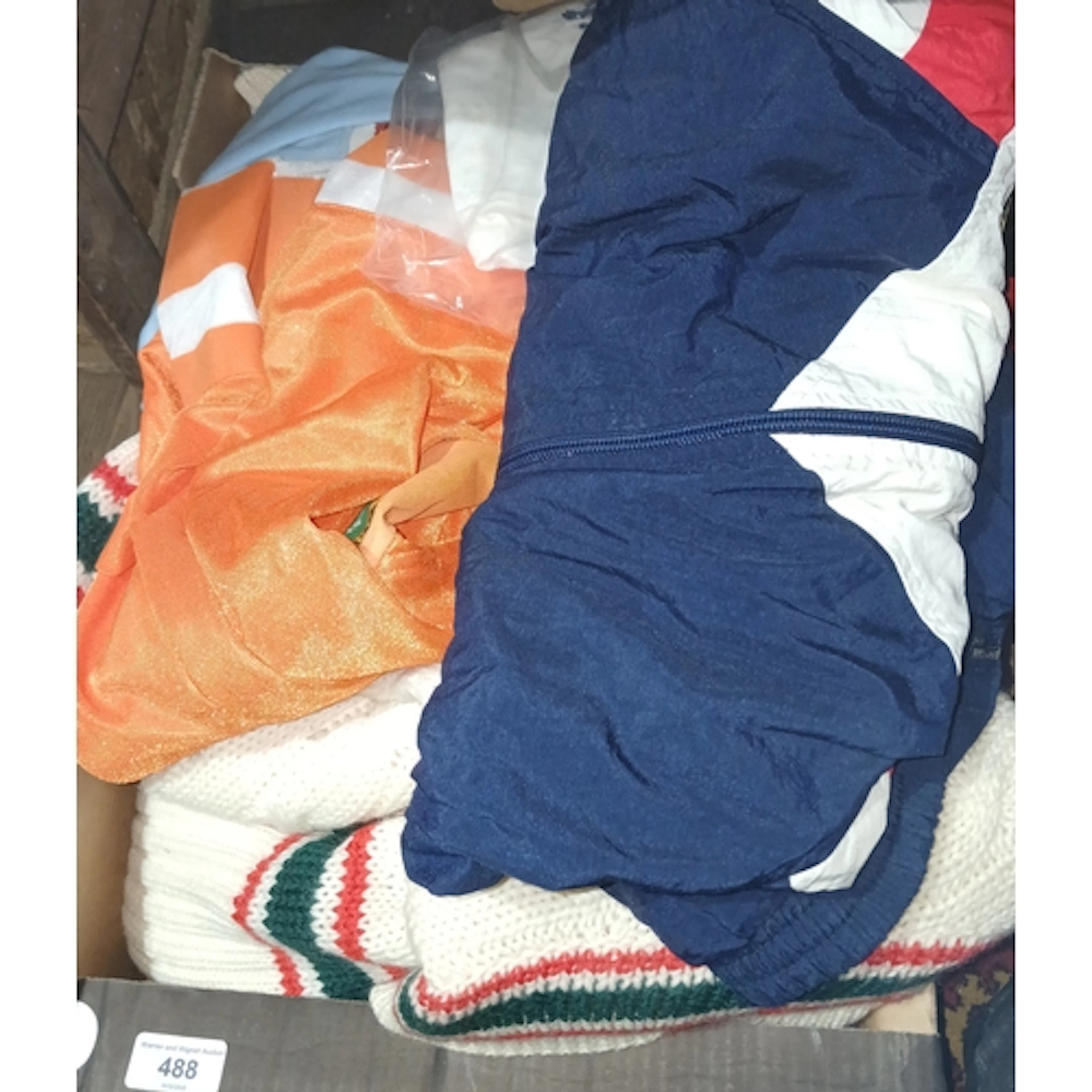 A box of assorted cricket clothing, some signed to include a...
