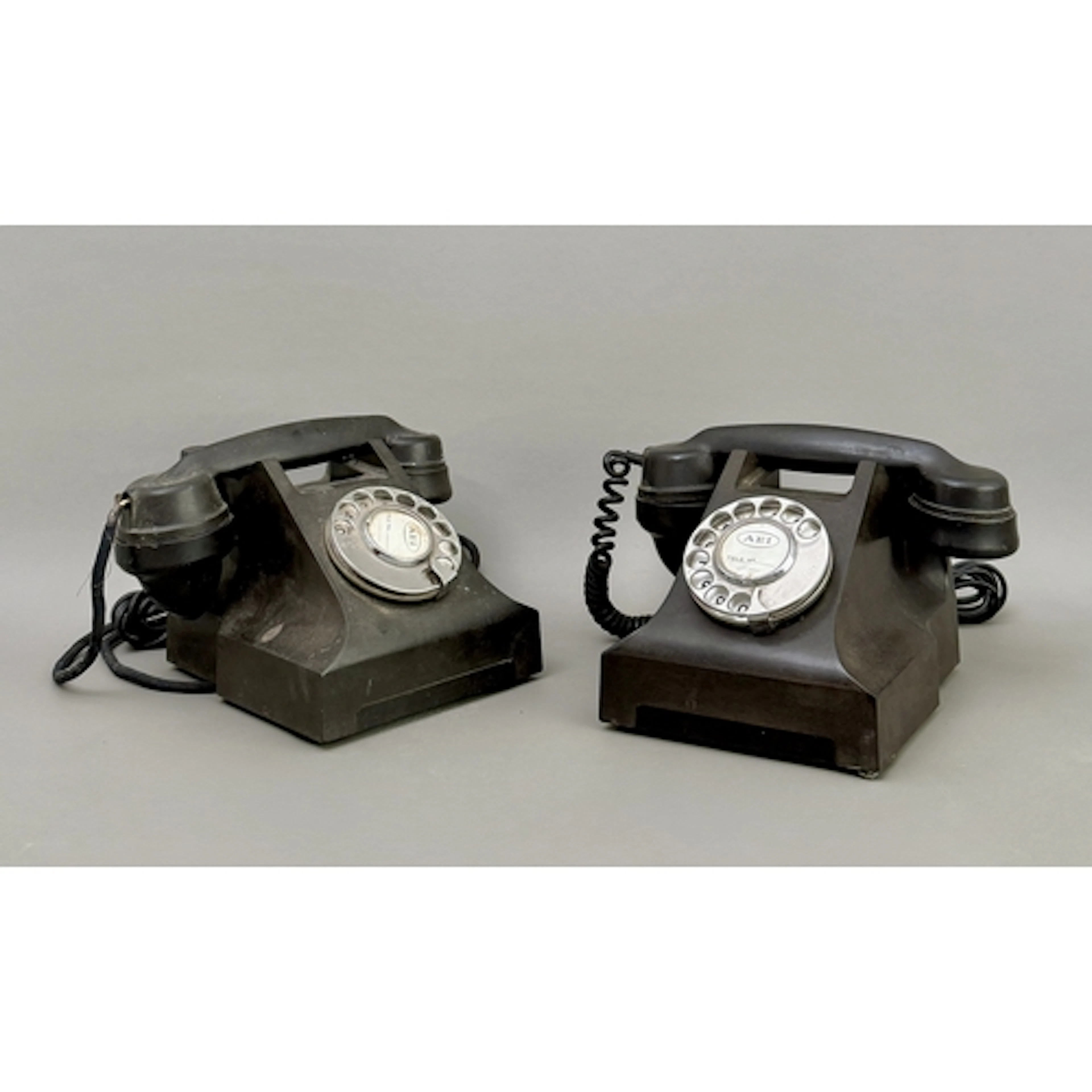 Two black AEP rotary dial telephones - bakelite, one stamped...