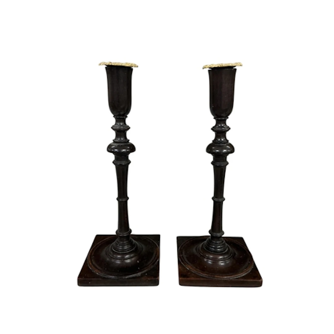 A pair of early 19th century turned mahogany candlesticks wi...