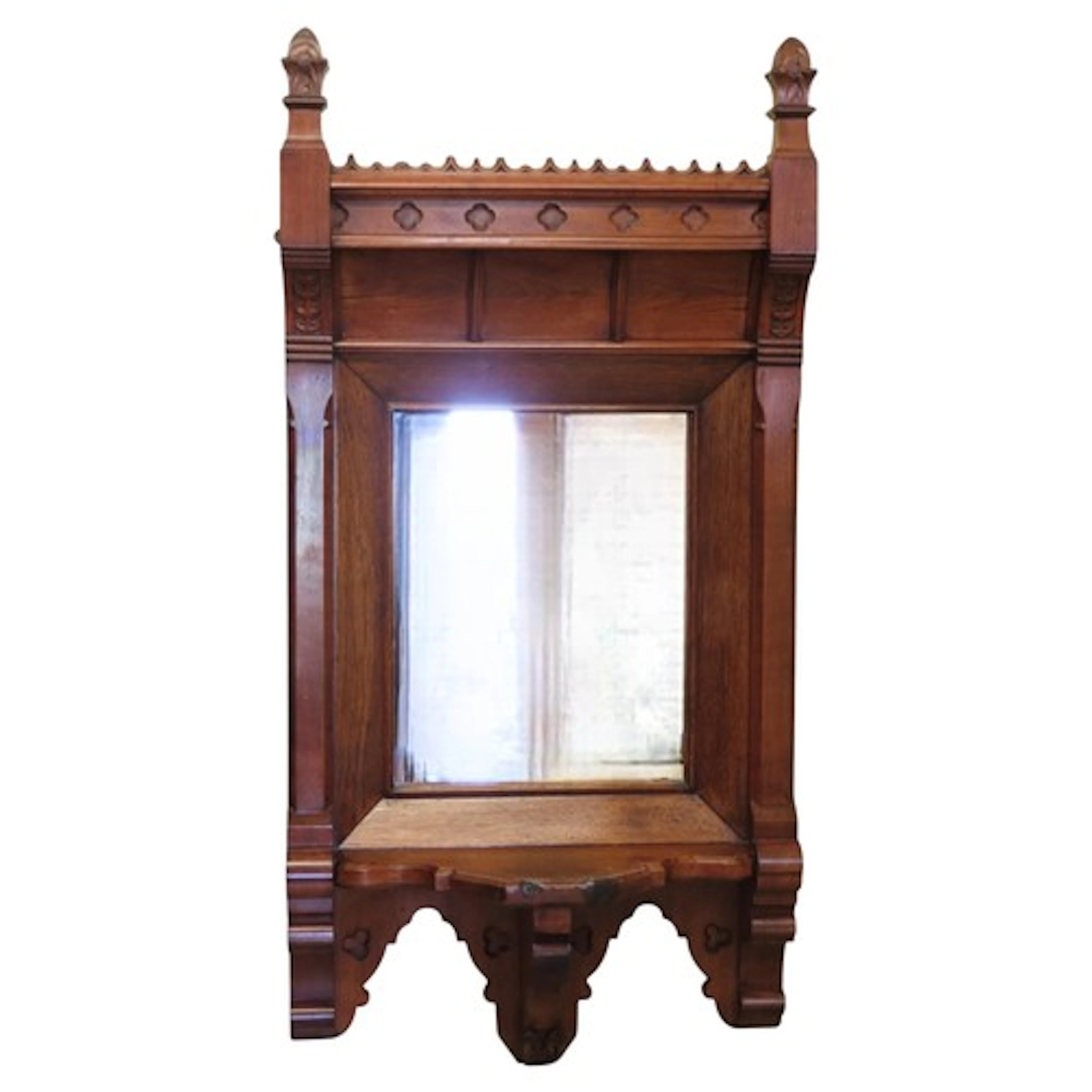 A Victorian gothic wall mirror in oak and walnut wood, suppo...