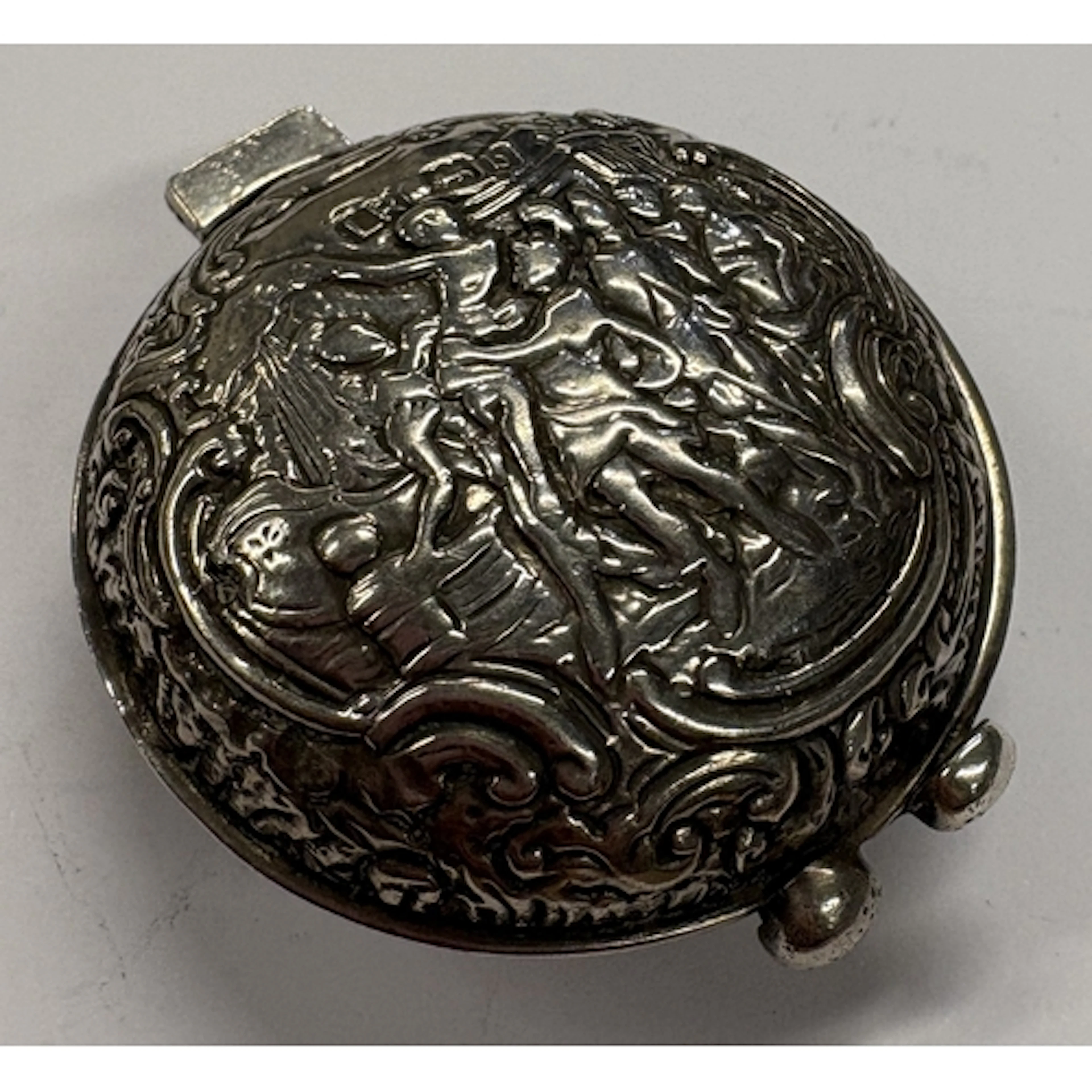 A Victorian silver watch case with embossed and chased decor...
