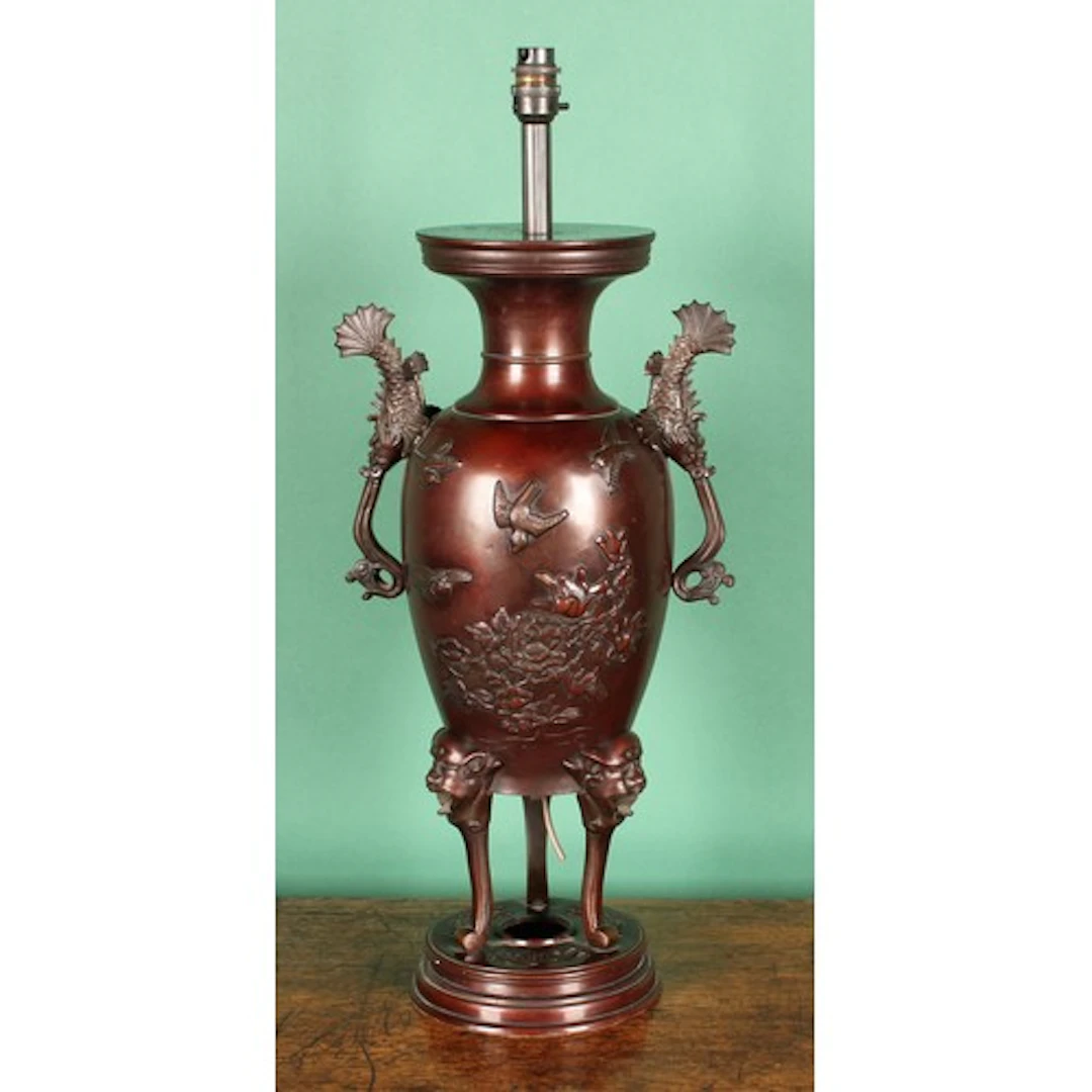 A Japanese brown patinated bronze vase, boldly cast with bir...