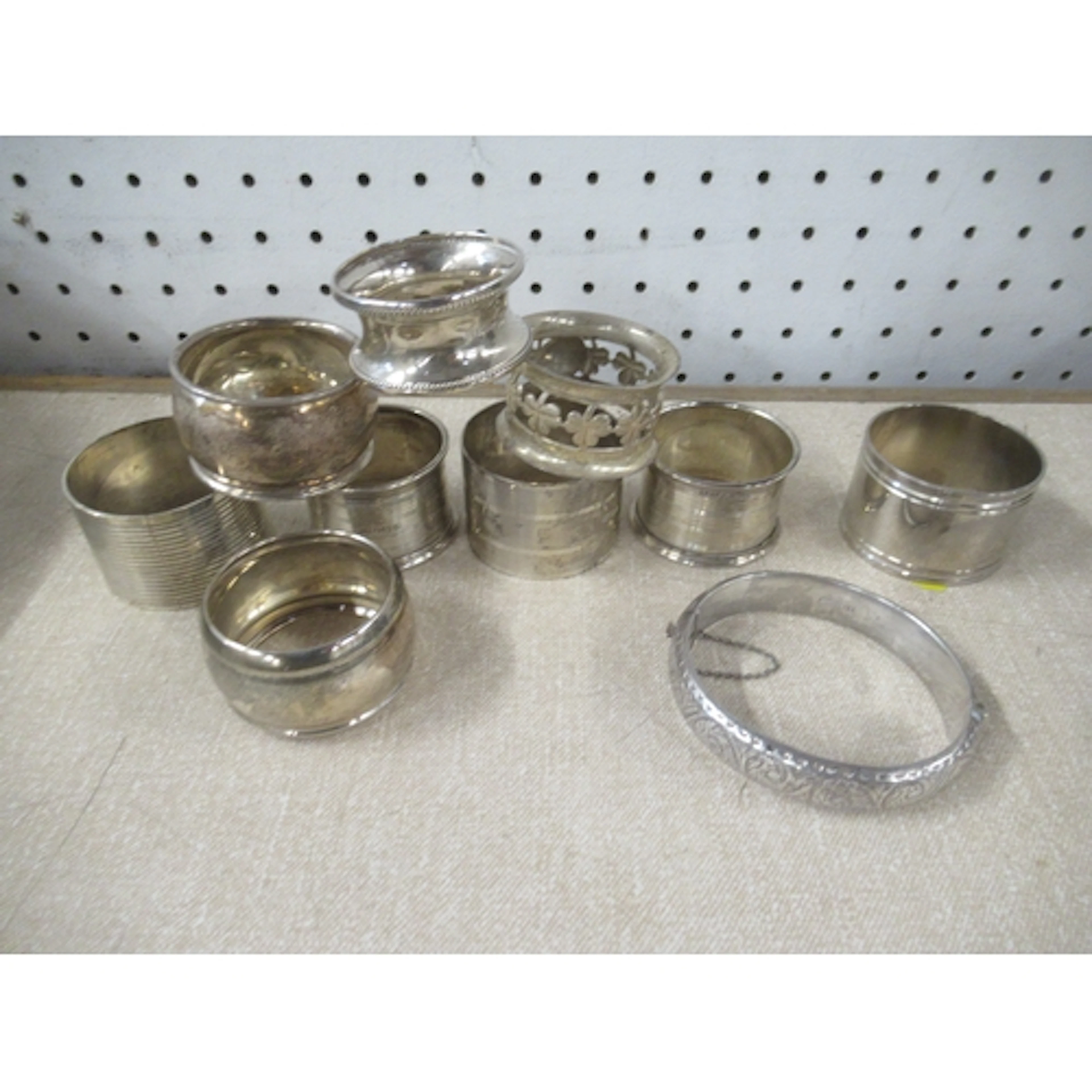 A collection of silver napkin rings, together with a silver ...