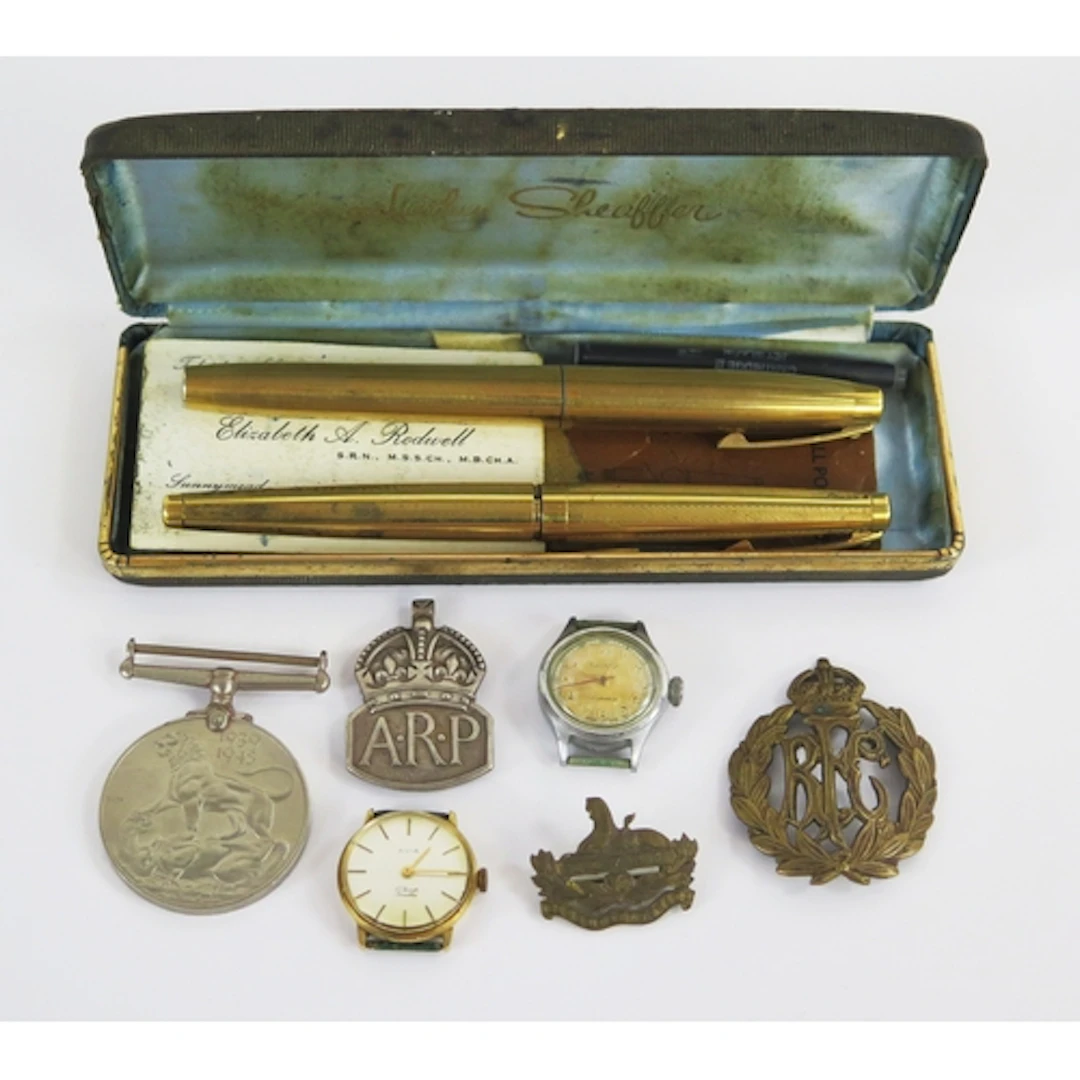 A WWII war medal, RFC badge, ARP badge, wristwatches, pens, ...