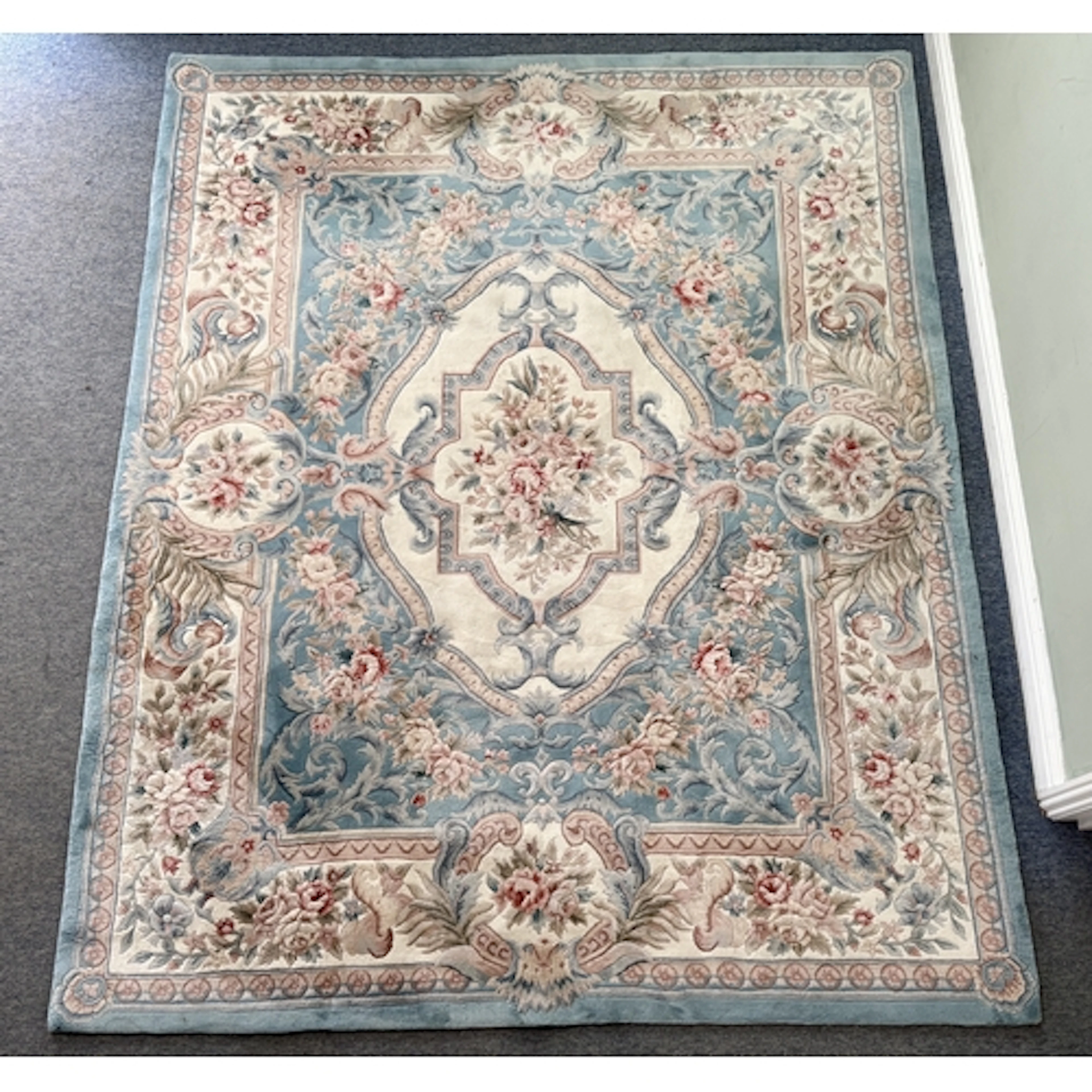 A large Chinese hand knotted wool rug - retailed by G.H. Fri...