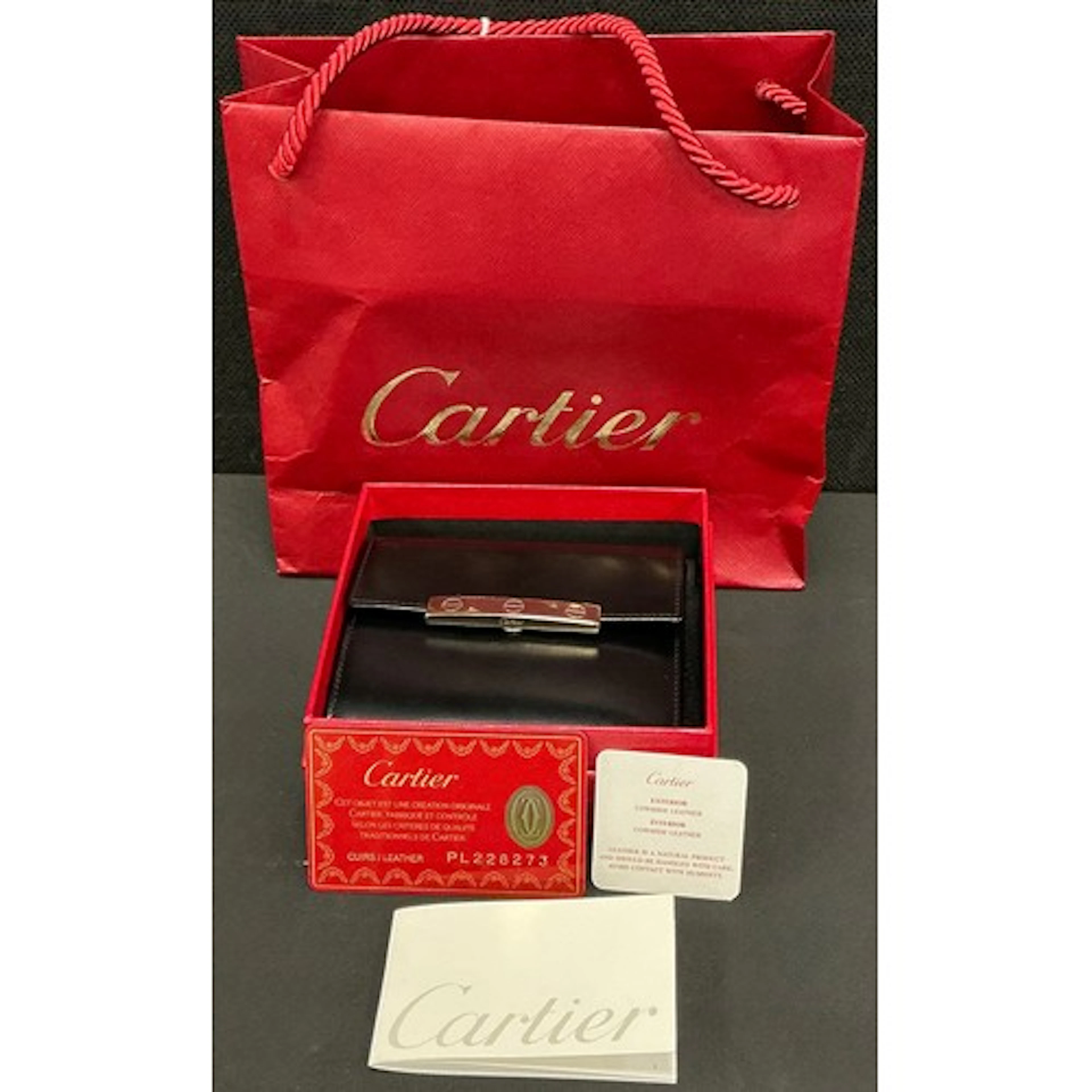 Cartier - a black leather Love collection wallet with iconic...