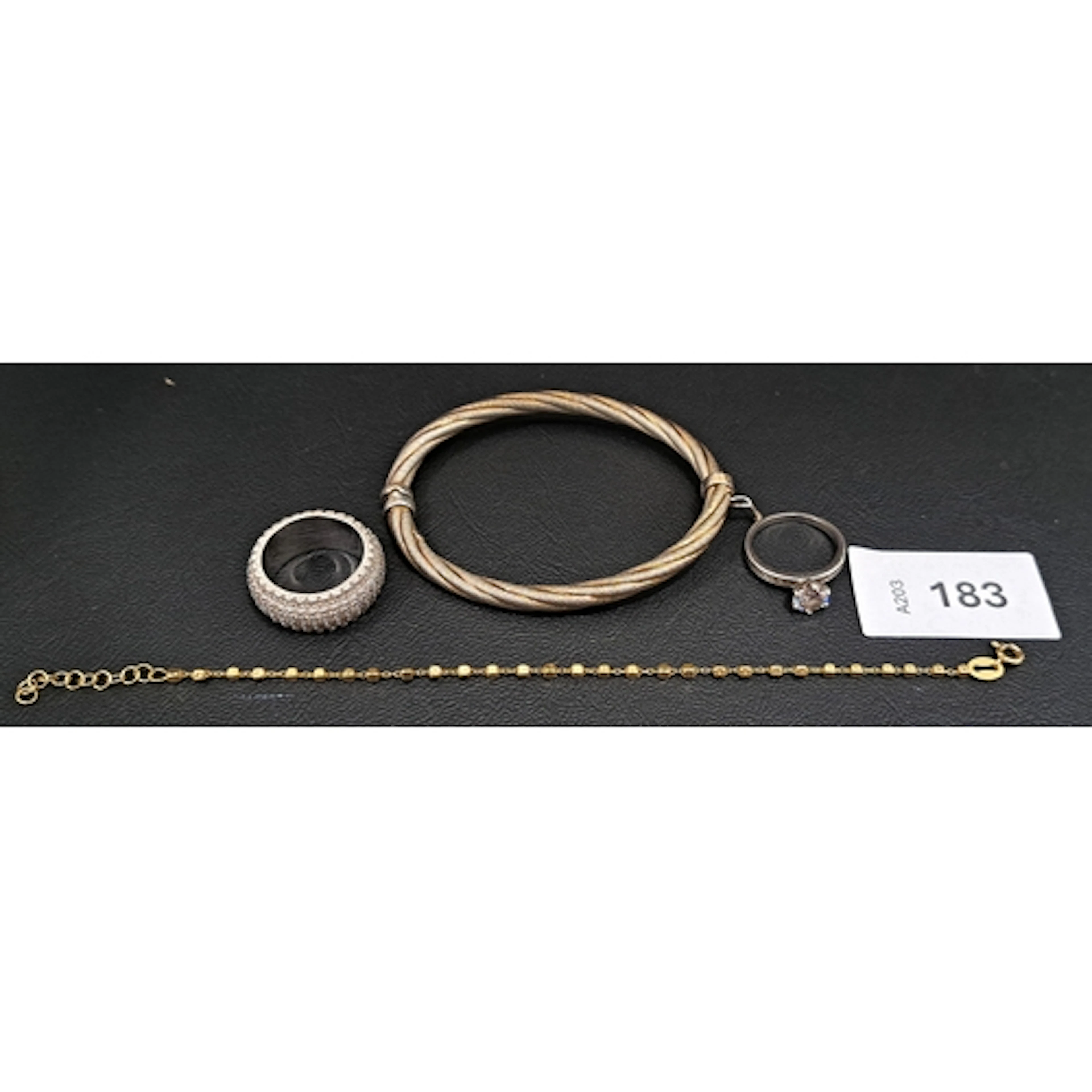 FOUR PIECES OF SILVER JEWELLERY comprising a twist design ba...