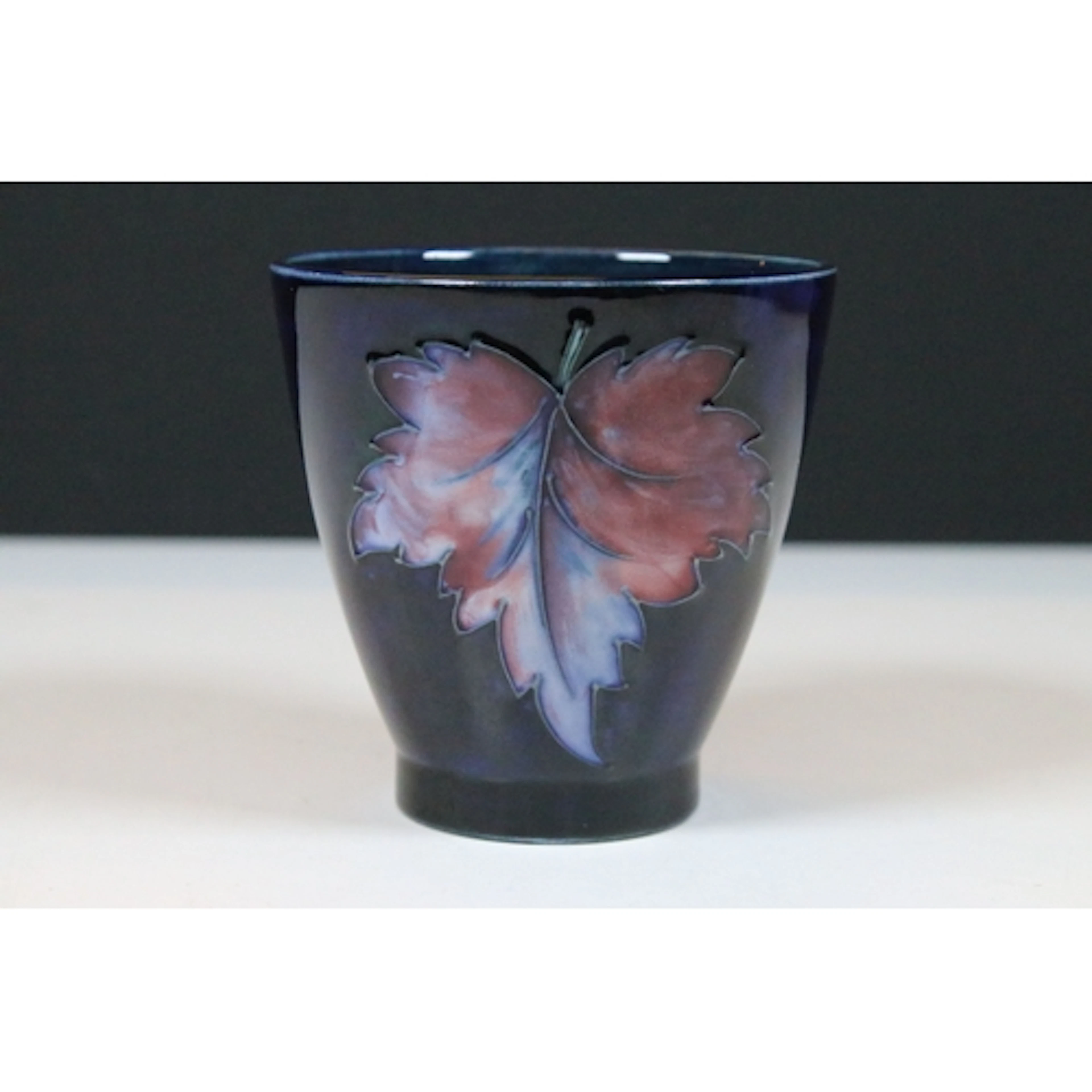 Moorcroft Pottery cup or vase of round tapering form, tube-l...