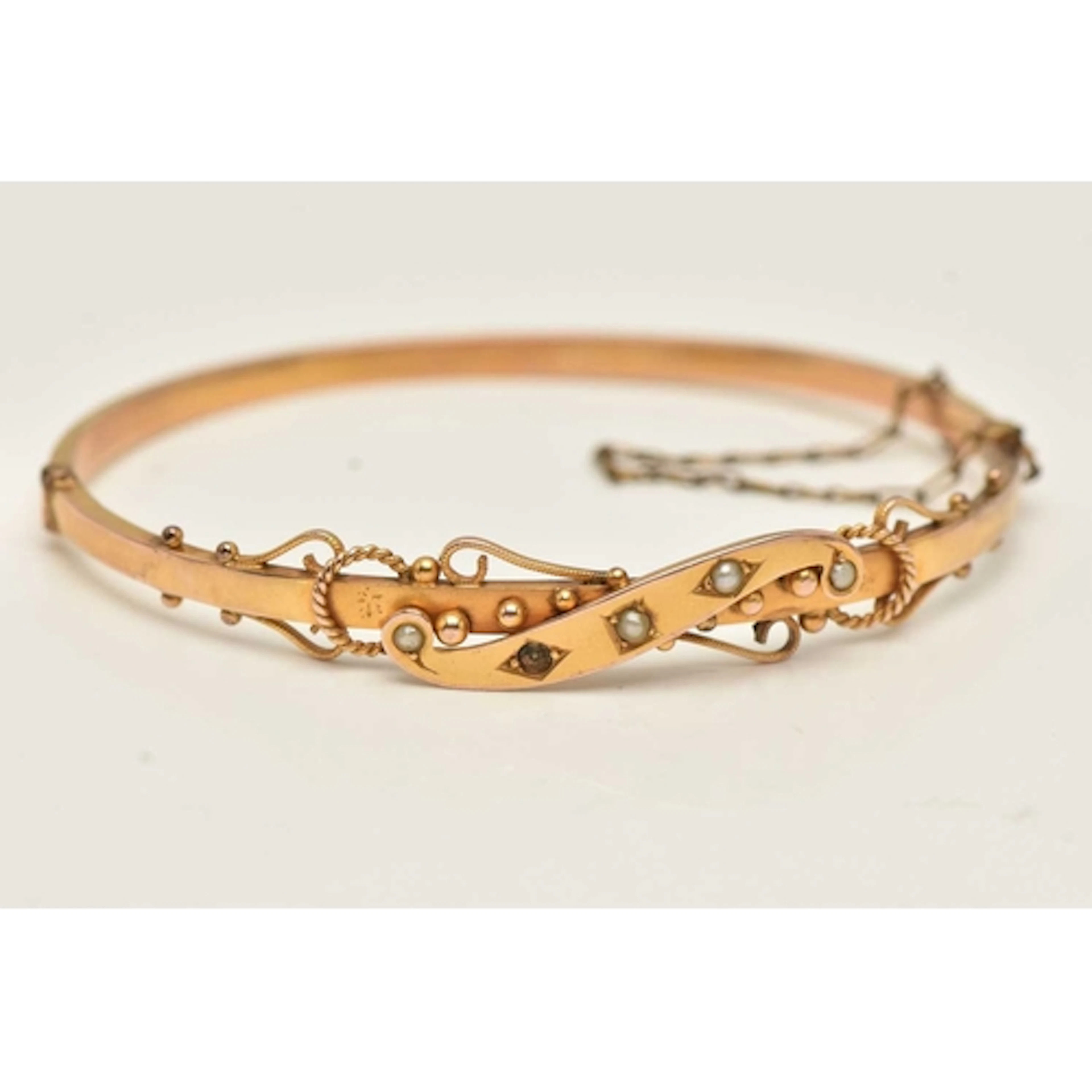 A CASED VICTORIAN BANGLE, hinged bangle with scroll design s...