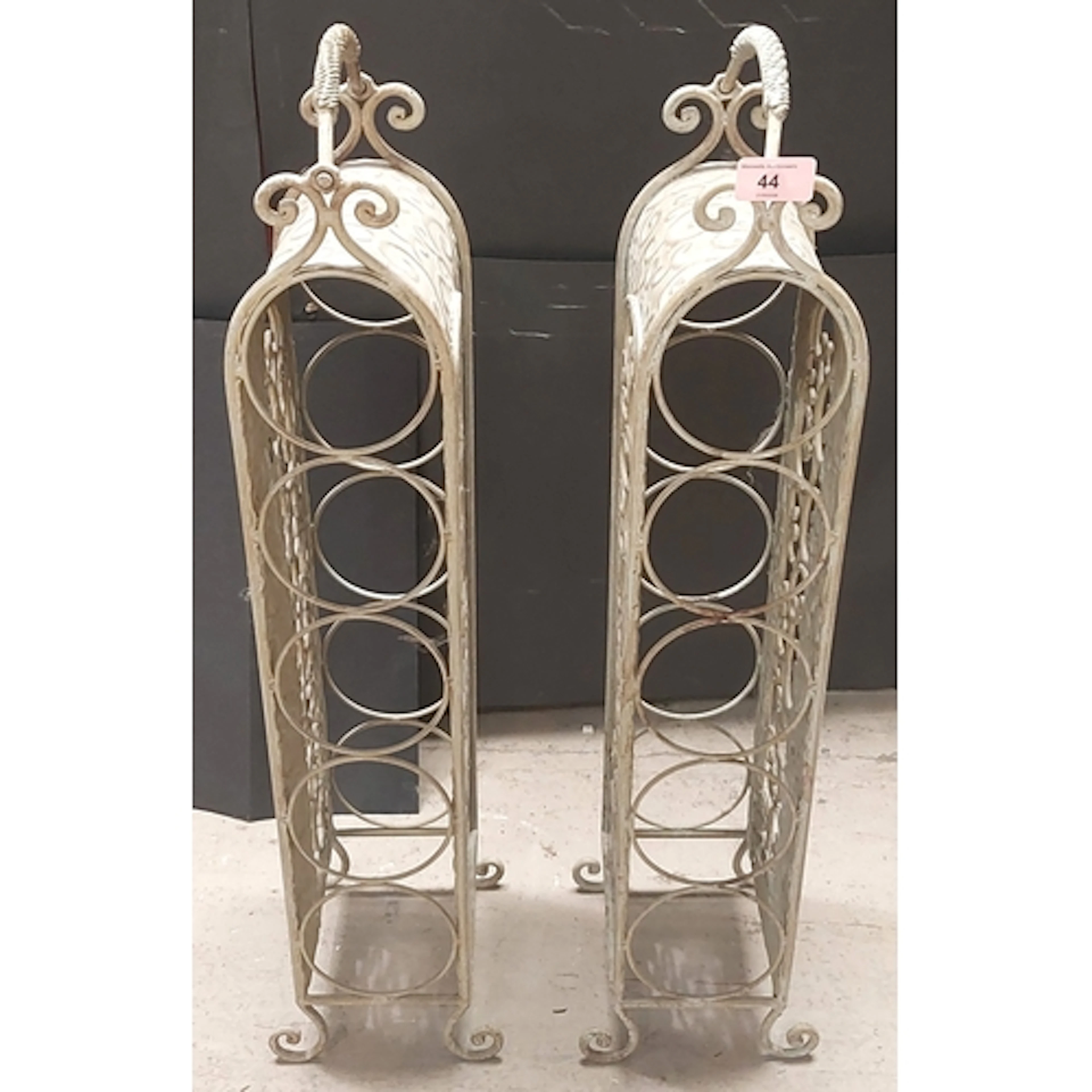 A pair of shabby chic metalwork wine racks.