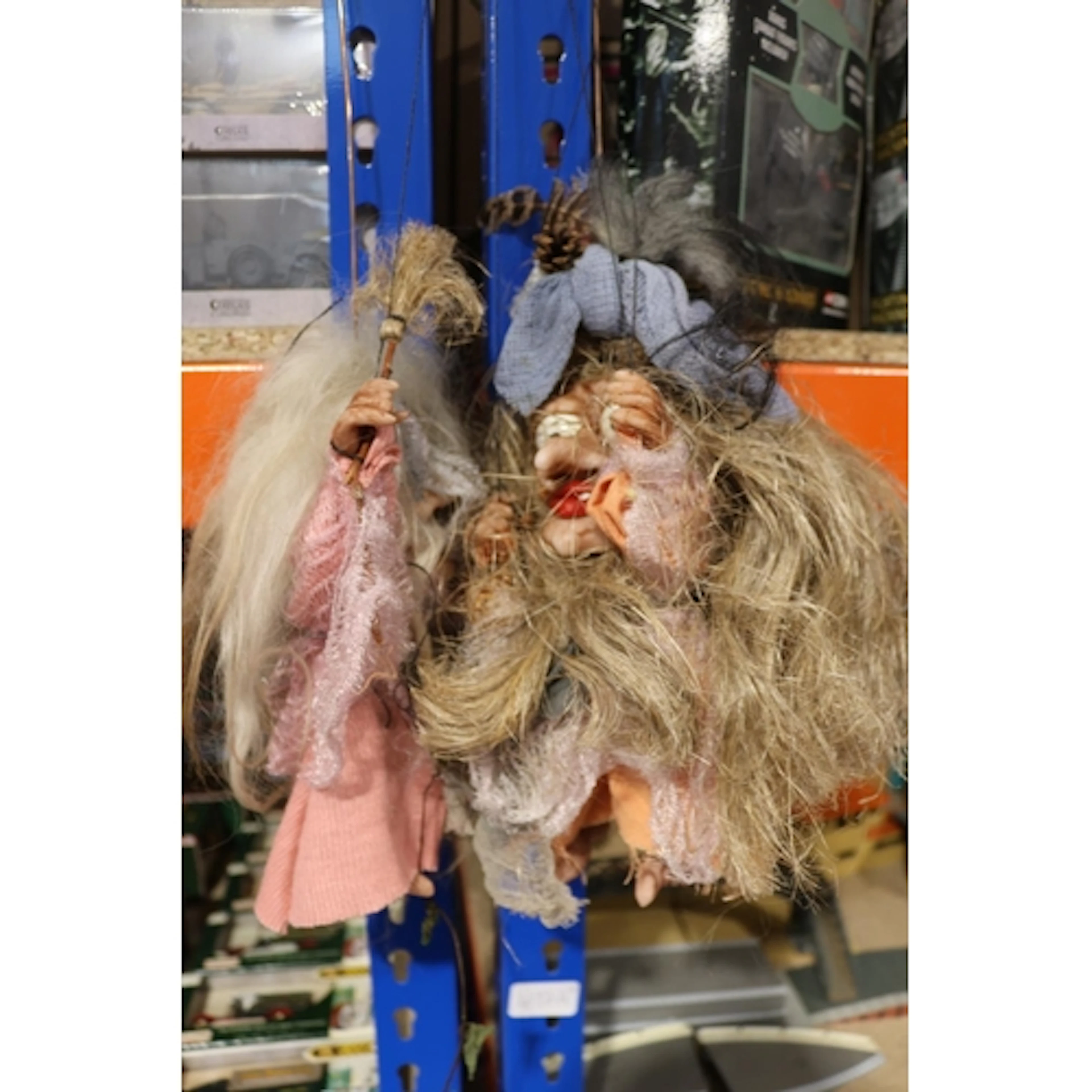 Two grotesque troll puppets.