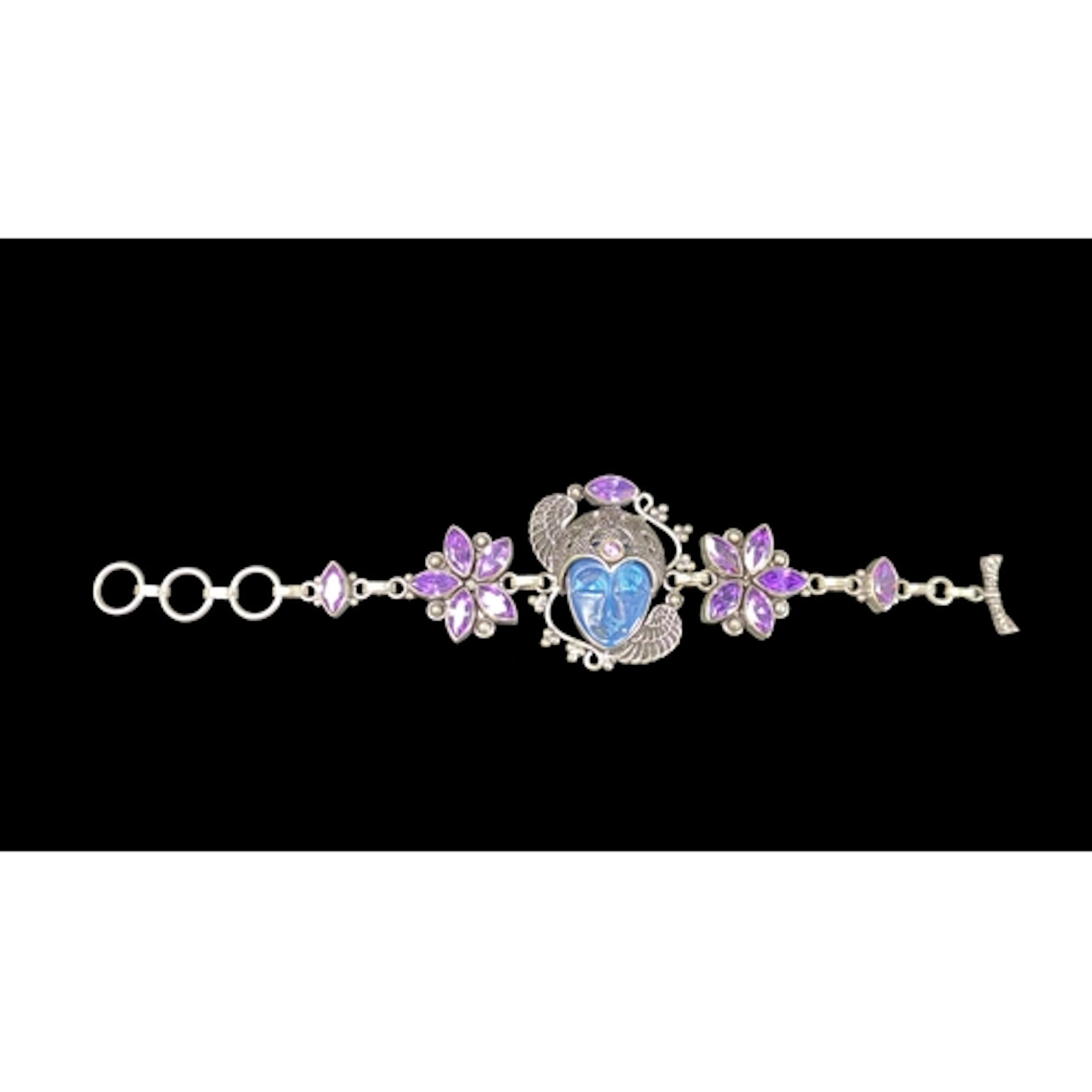 925 Silver bracelet, centred on a blue glass face within win...
