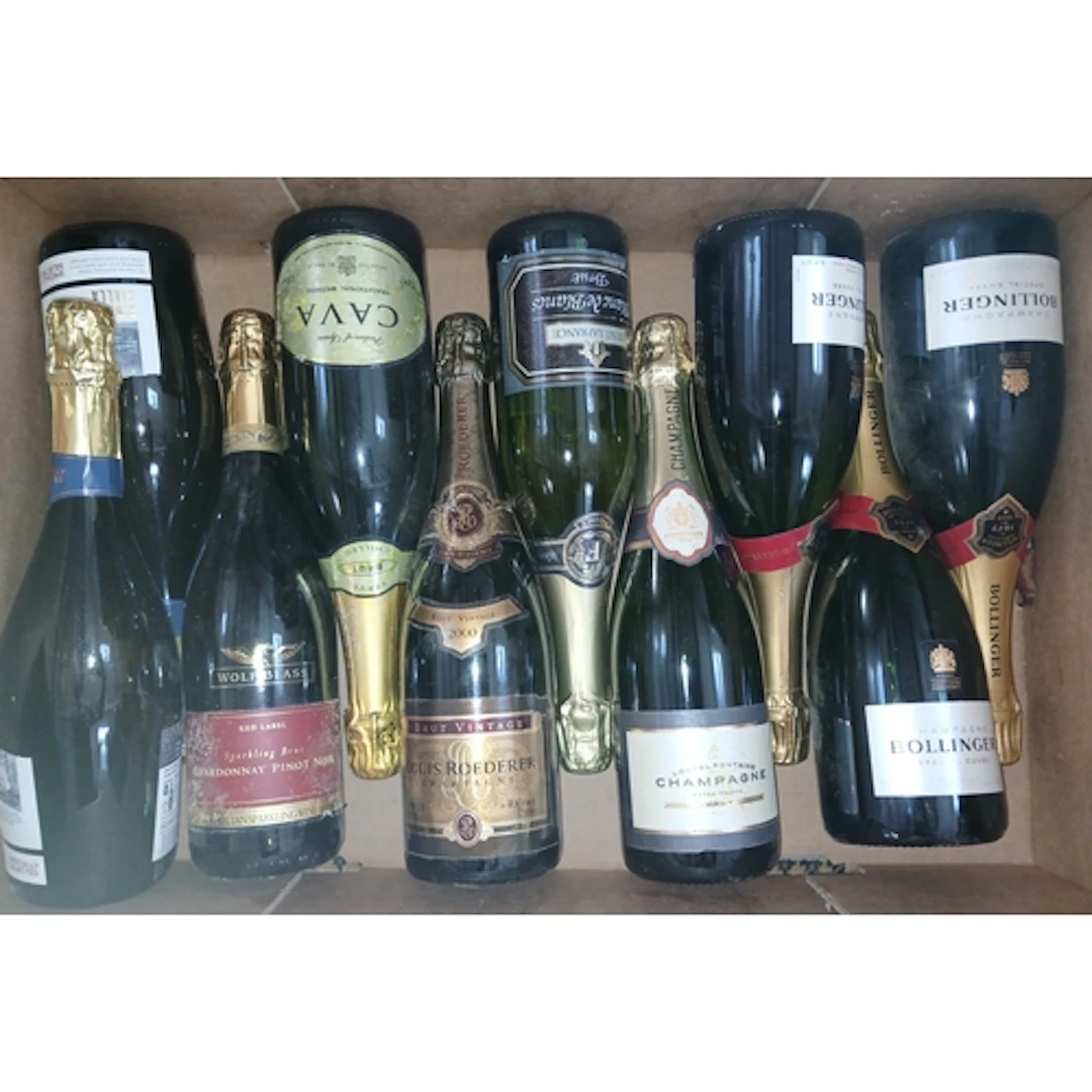 Nine bottles of assorted sparkling wine.