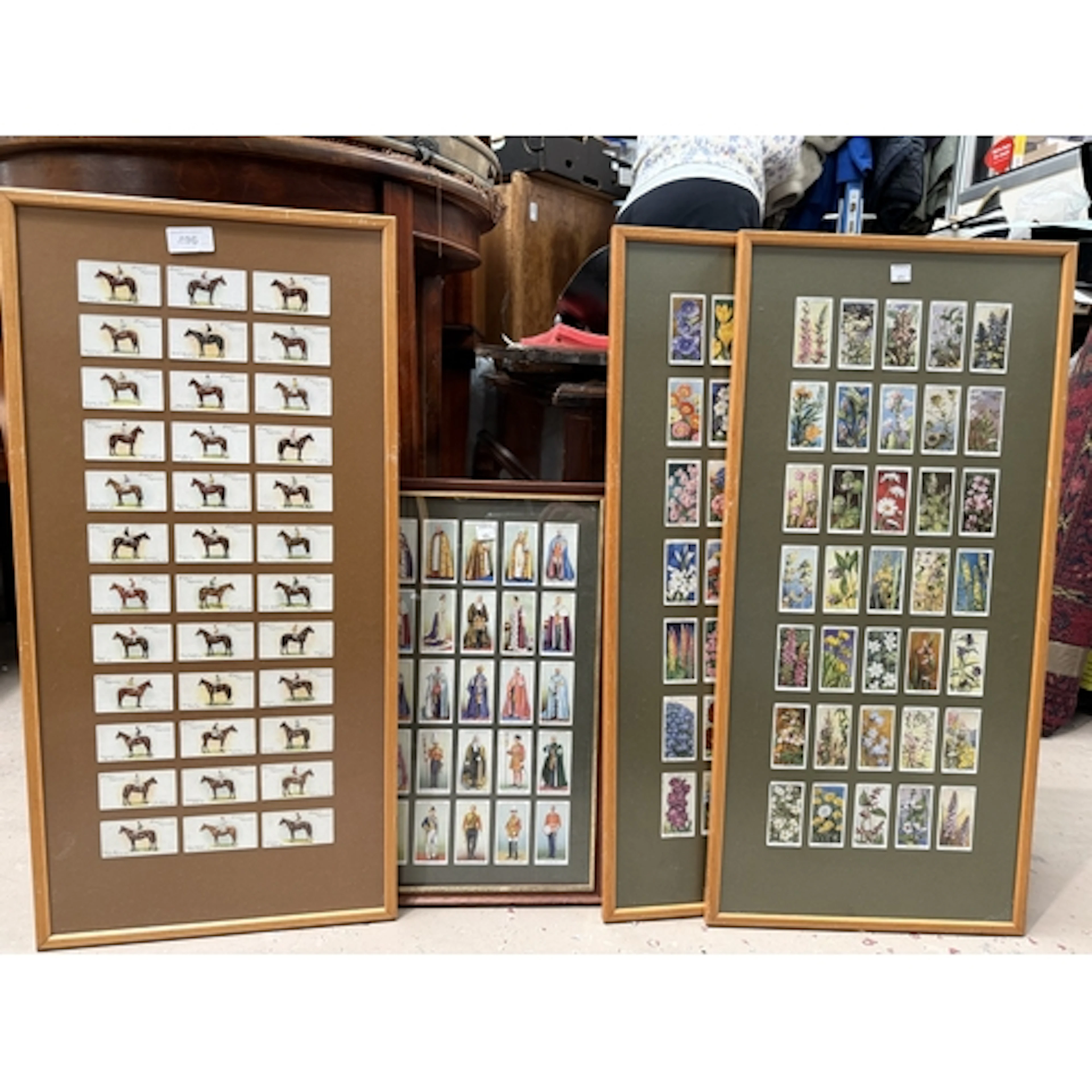 Four framed sets of cigarette cards:- horse racing, flowers,...