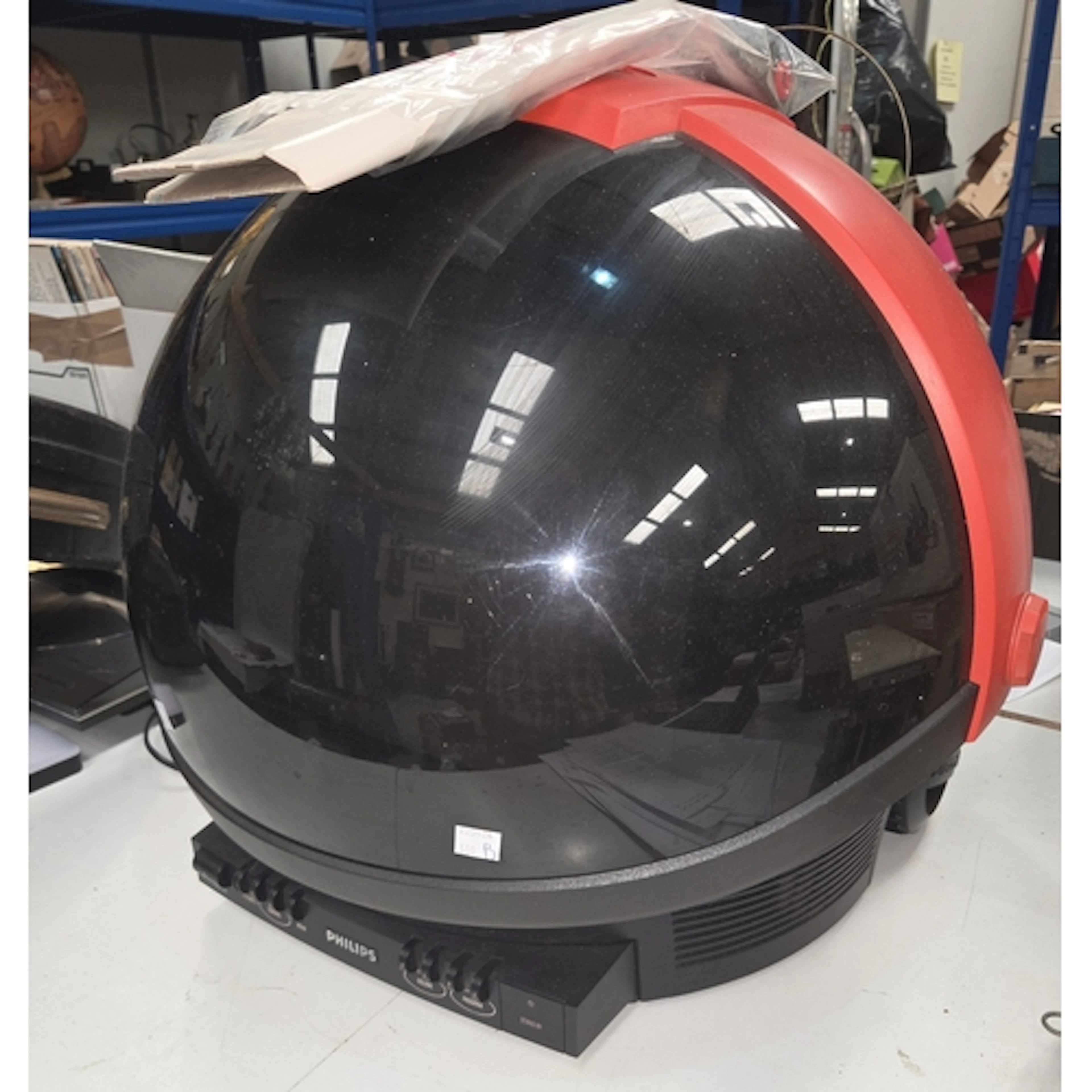 A vintage Philips Discover Space Helmet TV with remote contr...