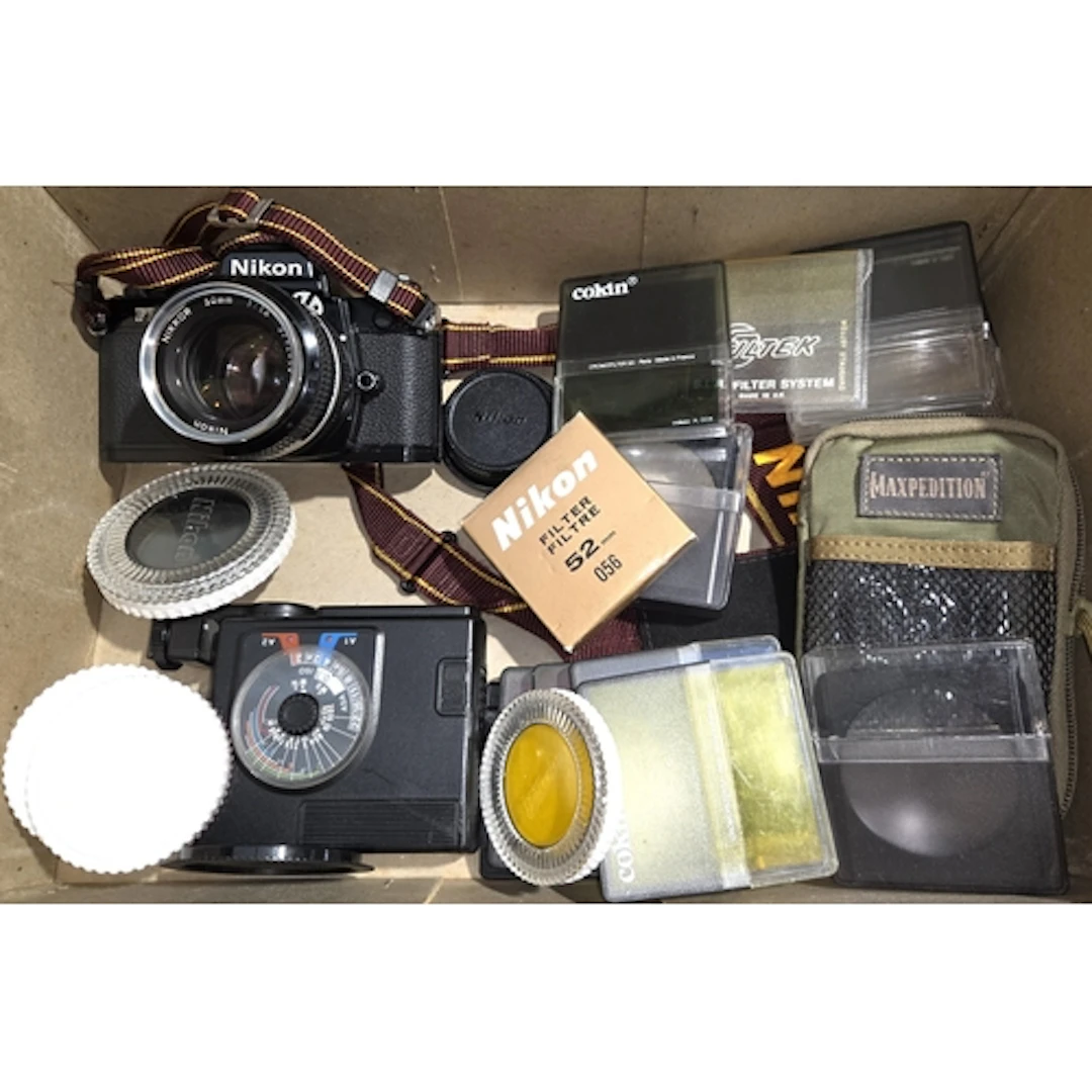 A Nikon FM2 SLR camera with 50mm Nikkor lens, a selection of...