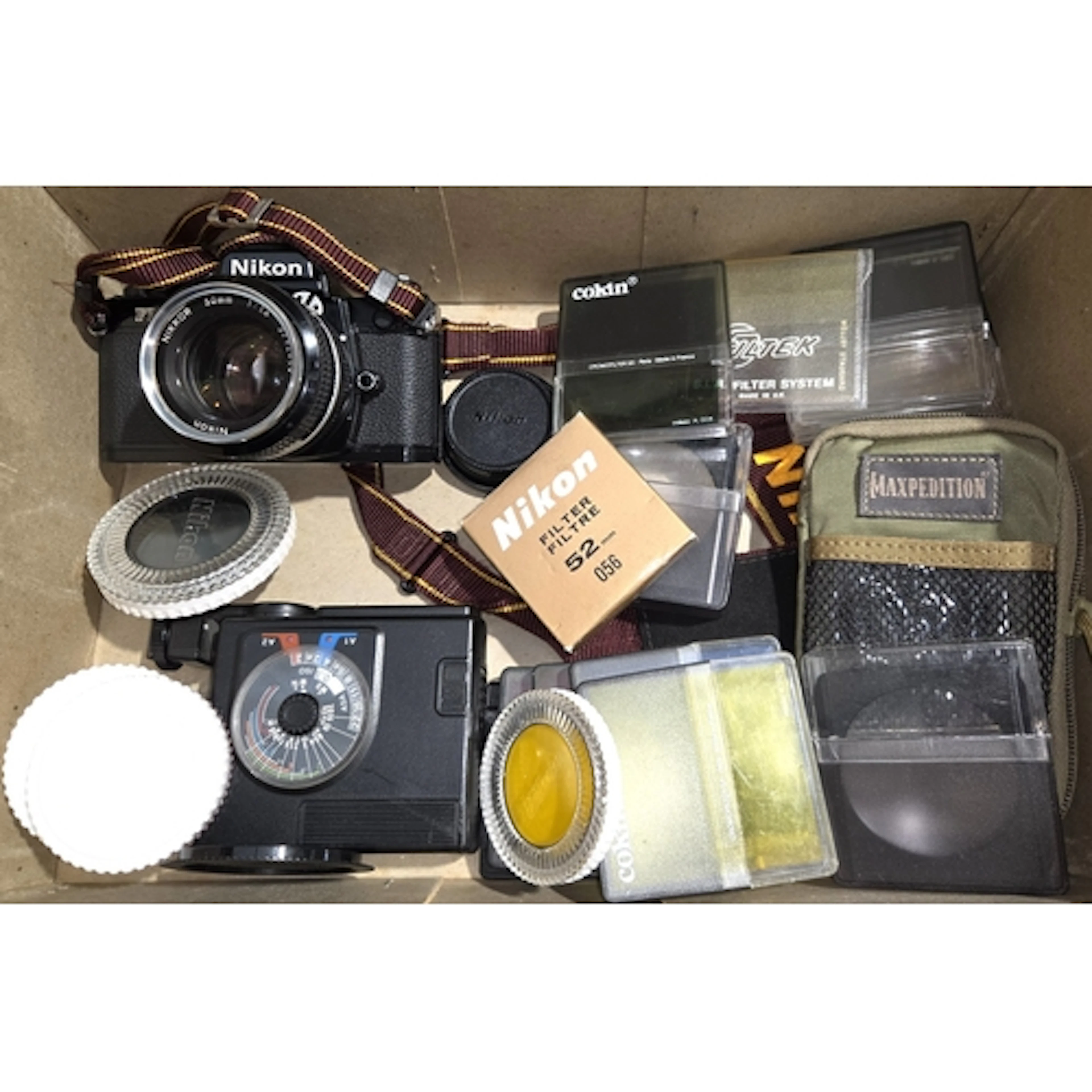 A Nikon FM2 SLR camera with 50mm Nikkor lens, a selection of...