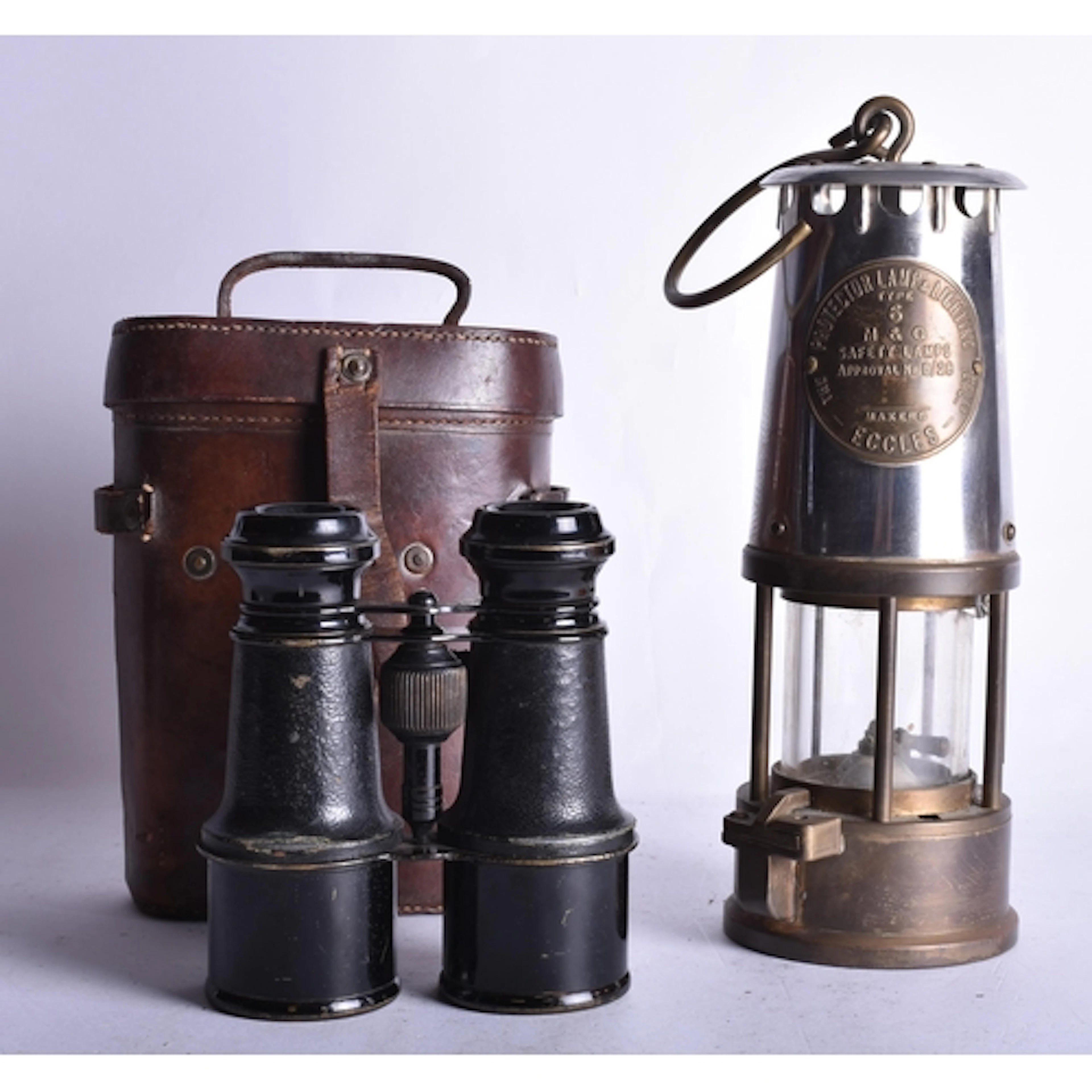 A PAIR OF ANTIQUE MILITARY BINOCULARS together with a miners...