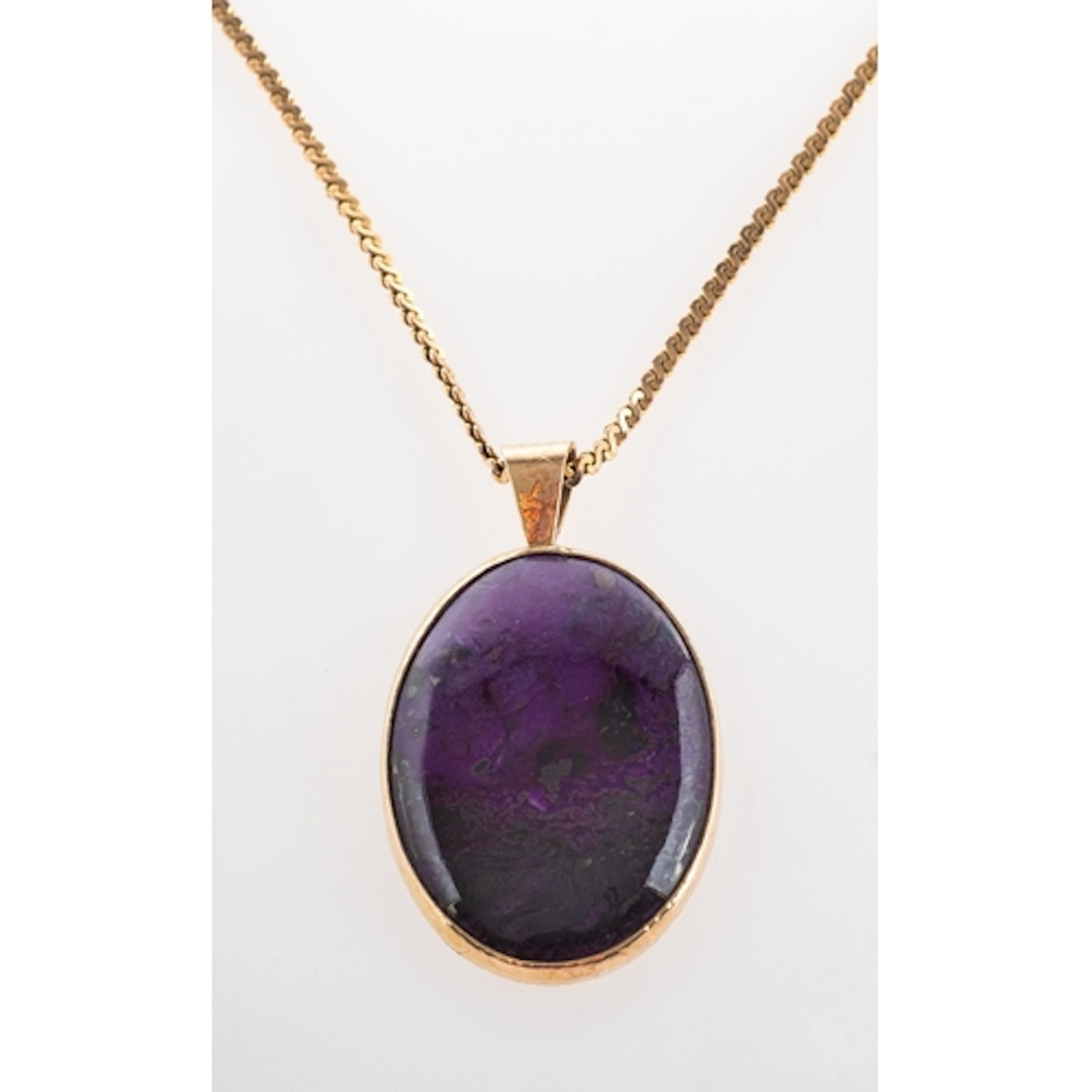 A 9ct gold mounted oval cut sugilite pendant with chain (app...