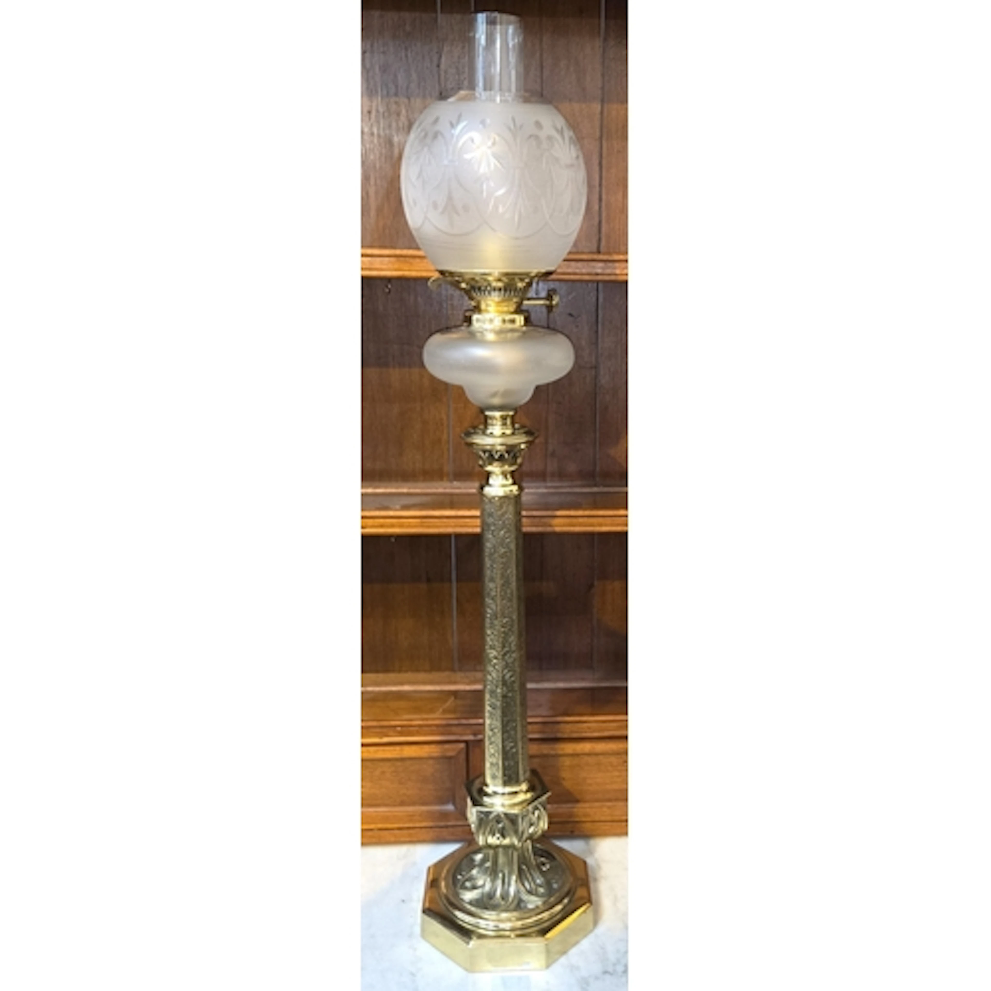 A VICTORIAN BRASS OIL LAMP, tapering octagonal column on Got...