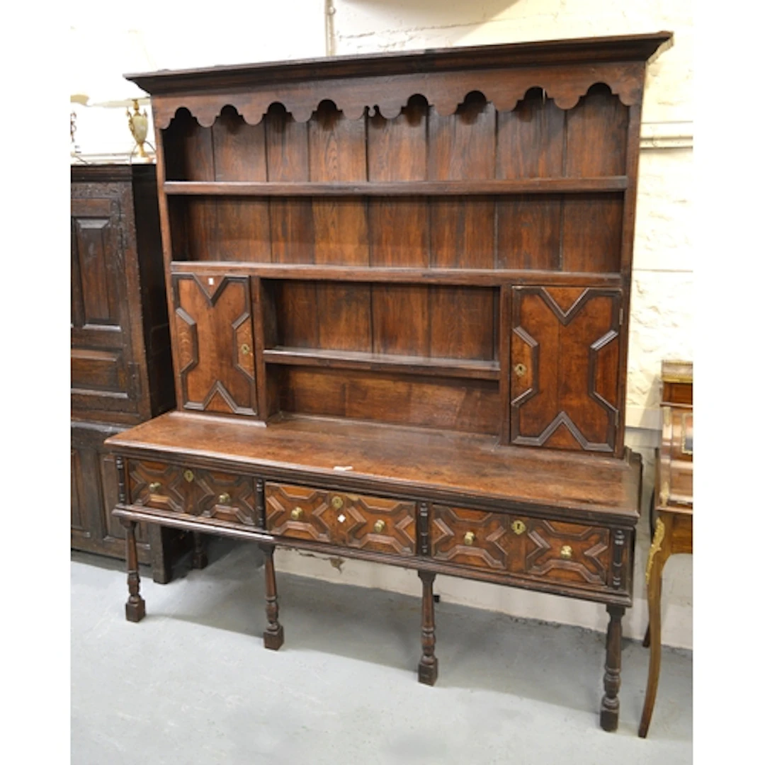 Antique oak dresser, the boarded shelf back with two moulded...