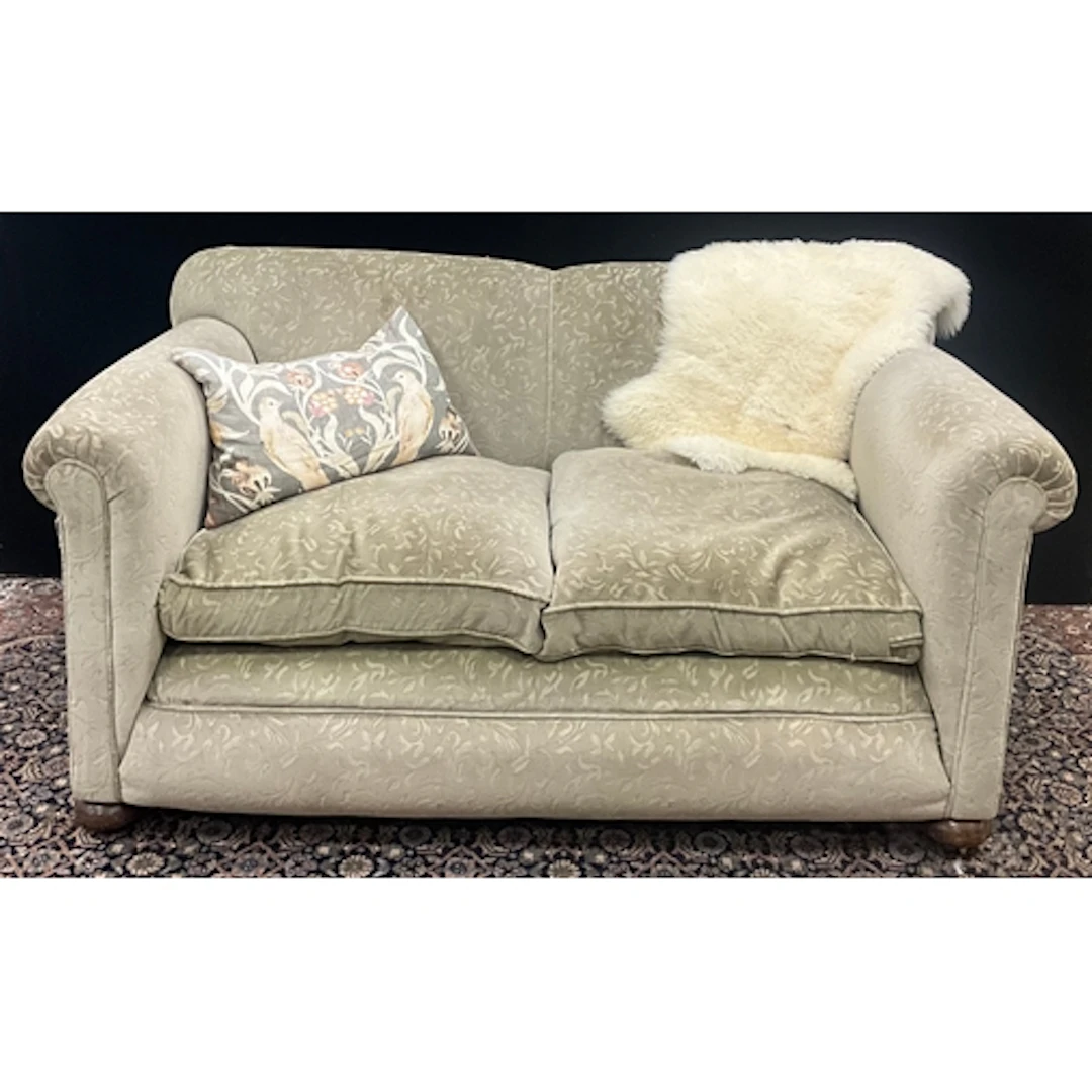A late 20th century two seater upholstered sofa, a humped ba...