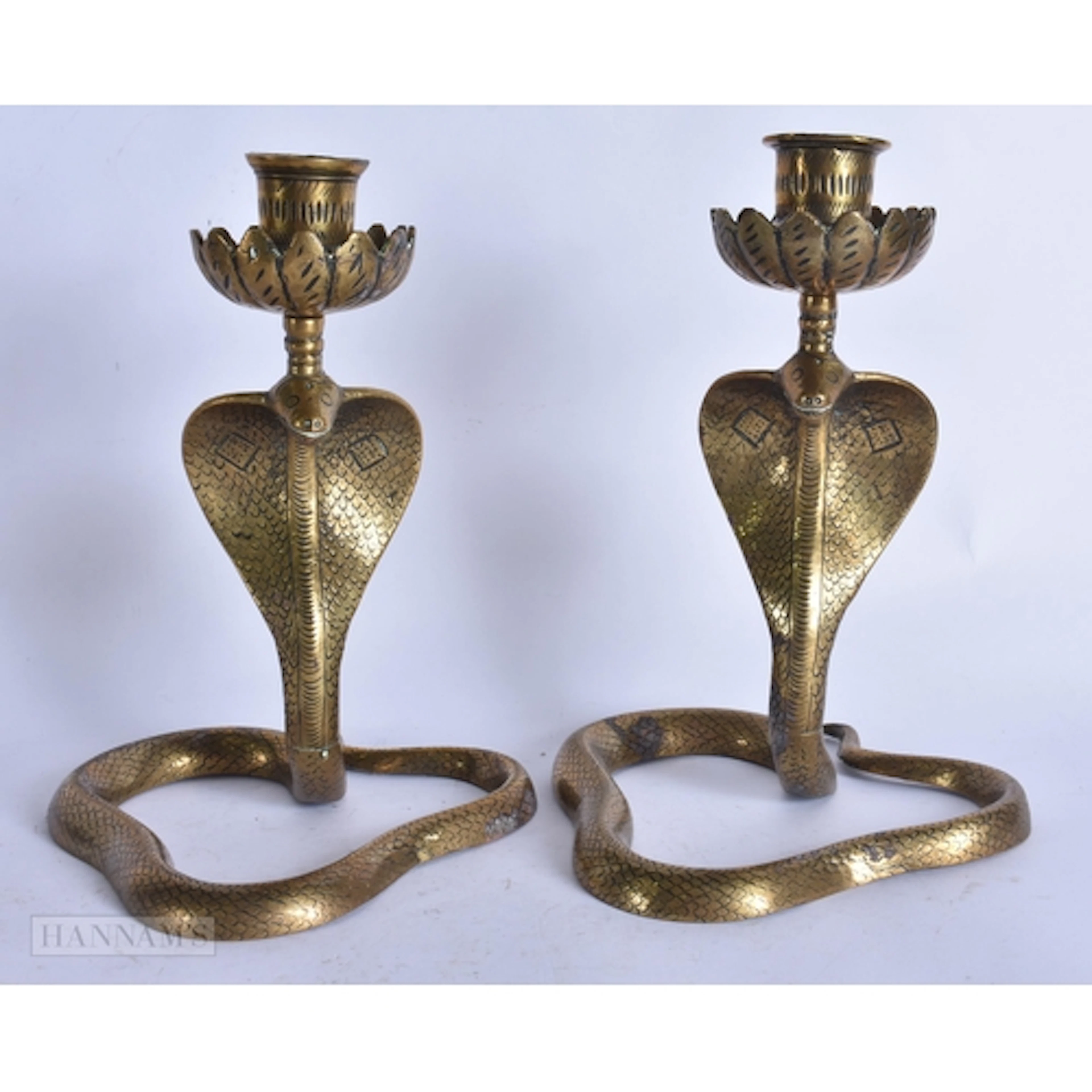 A PAIR OF 19TH CENTURY INDIAN BRONZE COBRA CANDLESTICKS. 21 ...