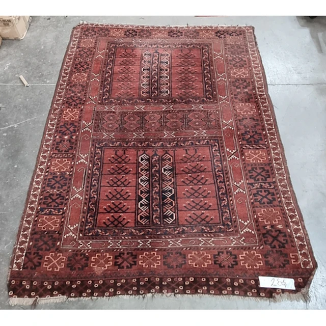 A Turkoman Rug with geometric designs on a red ground, 7ft x...