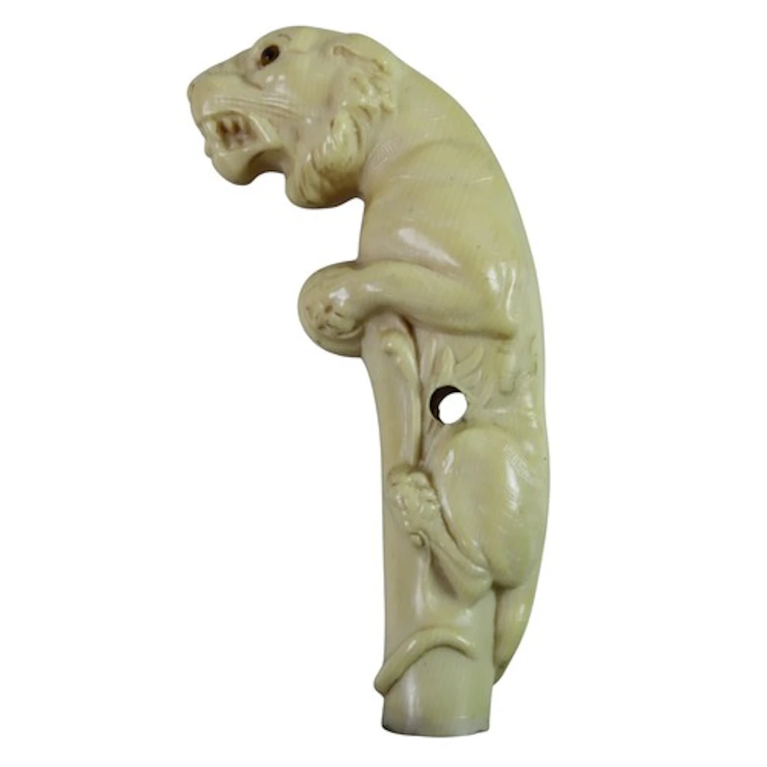 AN UNUSUAL MOULDED IVORINE WALKING HANDLE modelled as a tige...